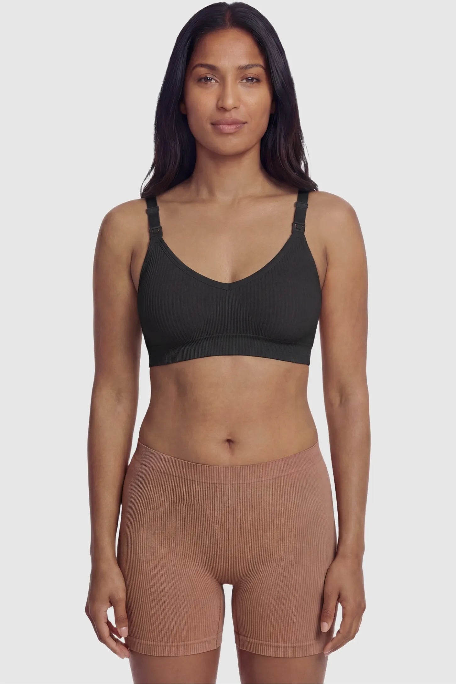 Ribbed Wireless Adjustable Shoulder Strap Nursing Bra Ribbed wireless adjustable strap nursing bra in black with stretchy fabric, front view on postpartum model
