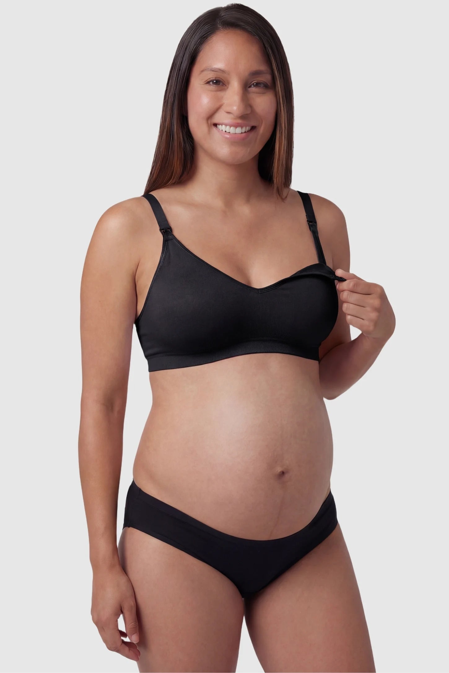 Seamless Front-Open Cross Wireless Nursing Bra Seamless front-open cross wireless nursing bra in black with front nursing access, front view on pregnant model