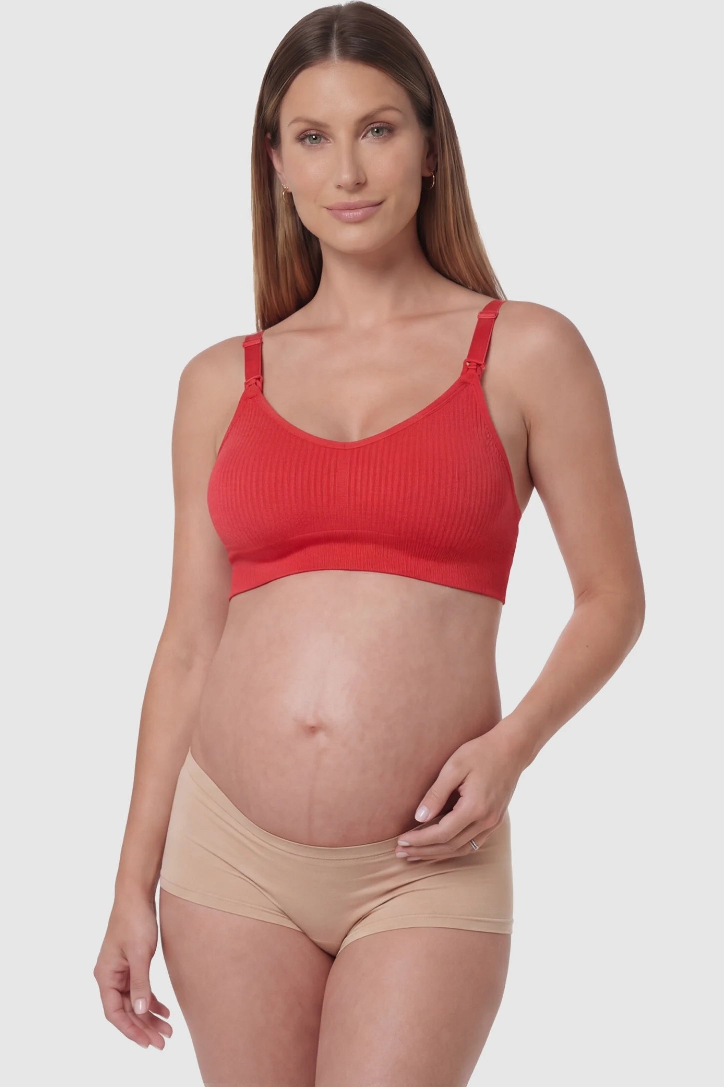 Full-Flap Seamless Top-Opening Nursing Bra Full-flap seamless top-opening nursing bra in bright red with 3D support, front view on pregnant model