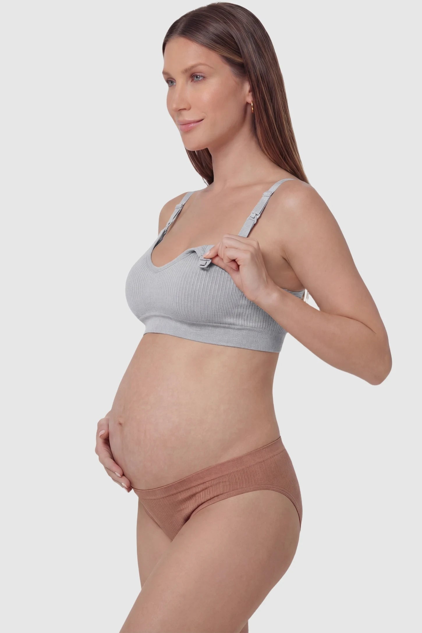 Ribbed Wireless Adjustable Shoulder Strap Nursing Bra Ribbed wireless adjustable strap nursing bra in gray with front open clasp for breastfeeding, side view on pregnant model