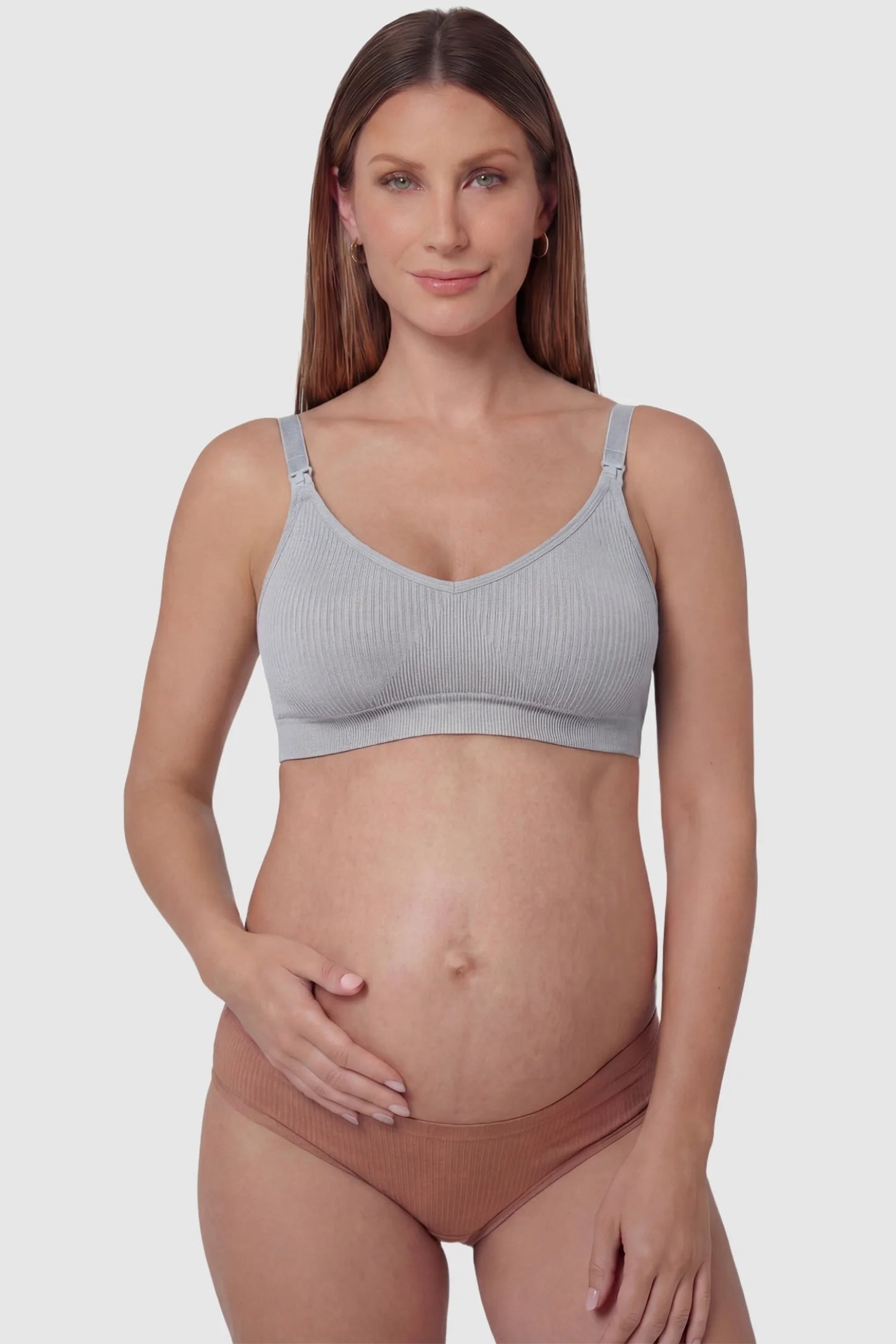 Ribbed Wireless Adjustable Shoulder Strap Nursing Bra Ribbed wireless adjustable strap nursing bra in gray with front clasp, front view on pregnant model