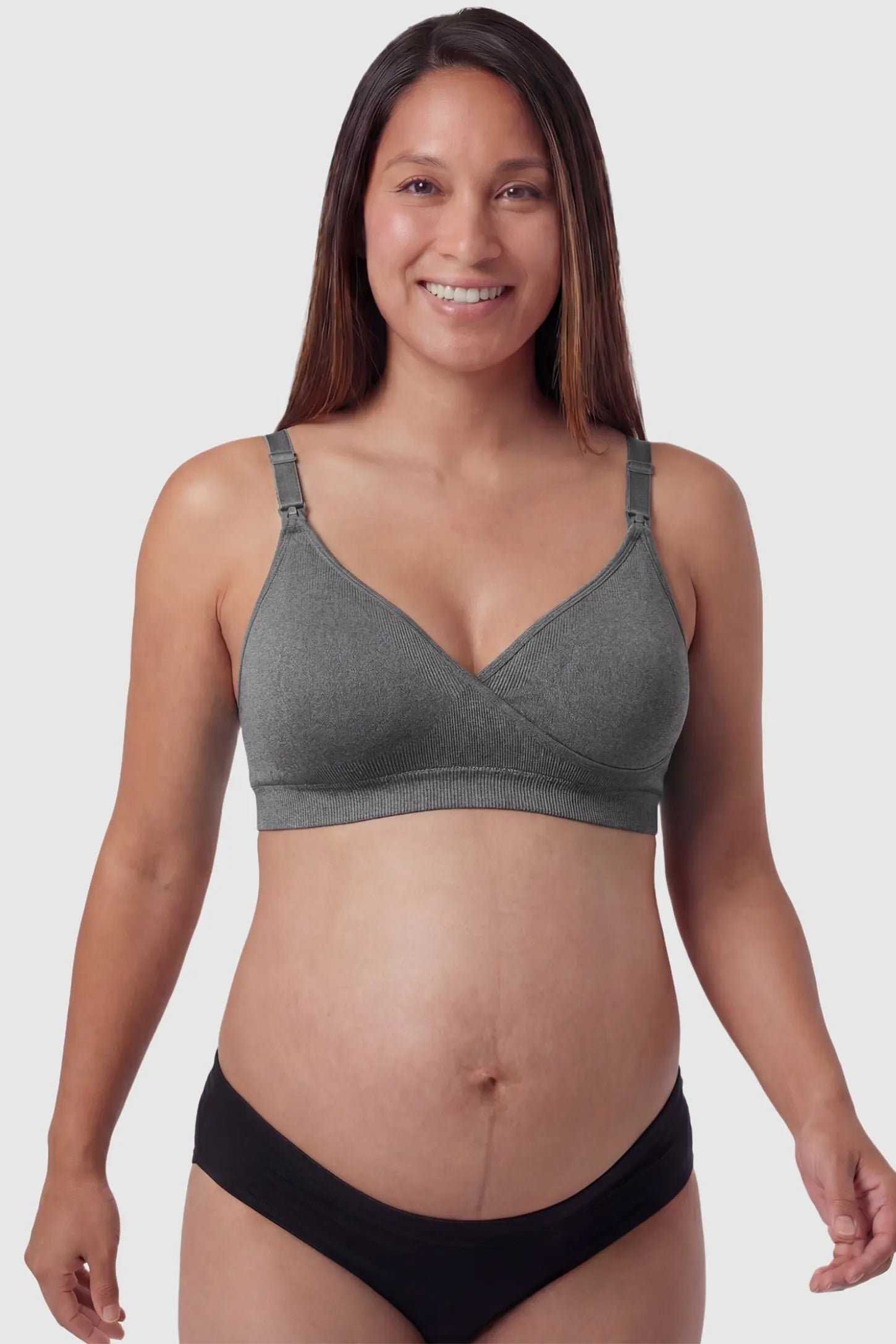 Seamless Front-Open Cross Wireless Nursing Bra Seamless front-open cross wireless nursing bra in gray with cross front access, front view on pregnant model