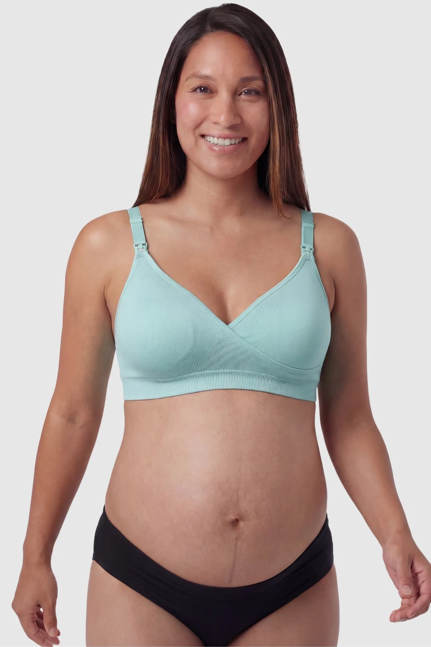Seamless Front-Open Cross Wireless Nursing Bra Seamless front-open cross wireless nursing bra in green with cross front access, front view on pregnant model