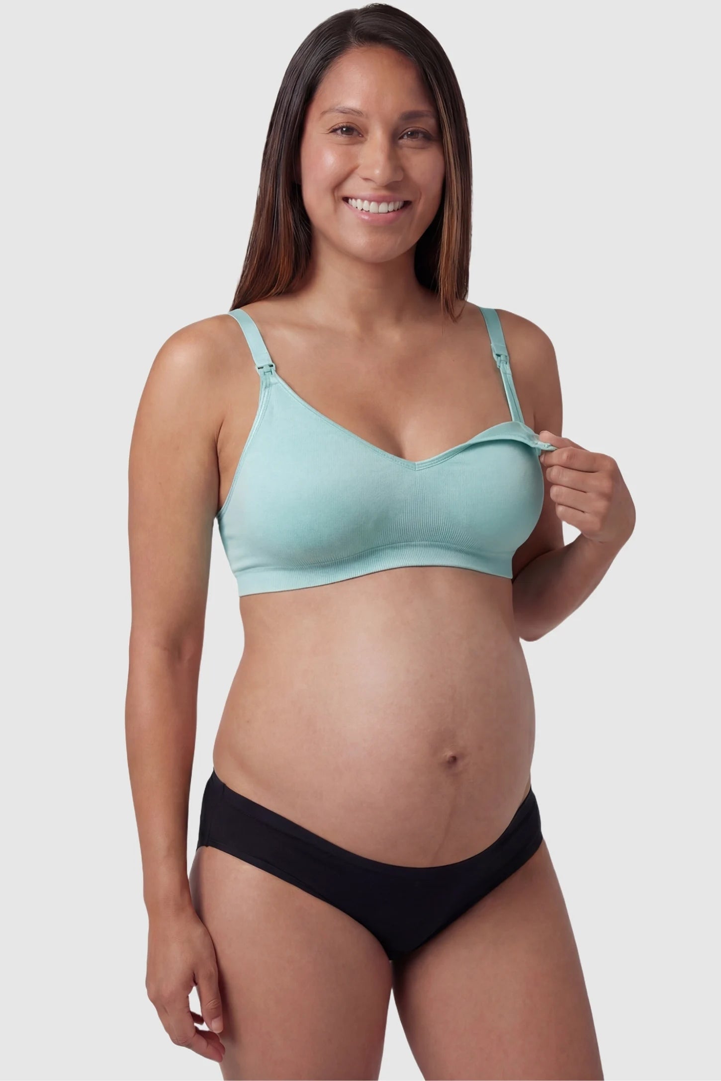 Seamless Front-Open Cross Wireless Nursing Bra Seamless front-open cross wireless nursing bra in green with front nursing access, front view on pregnant model