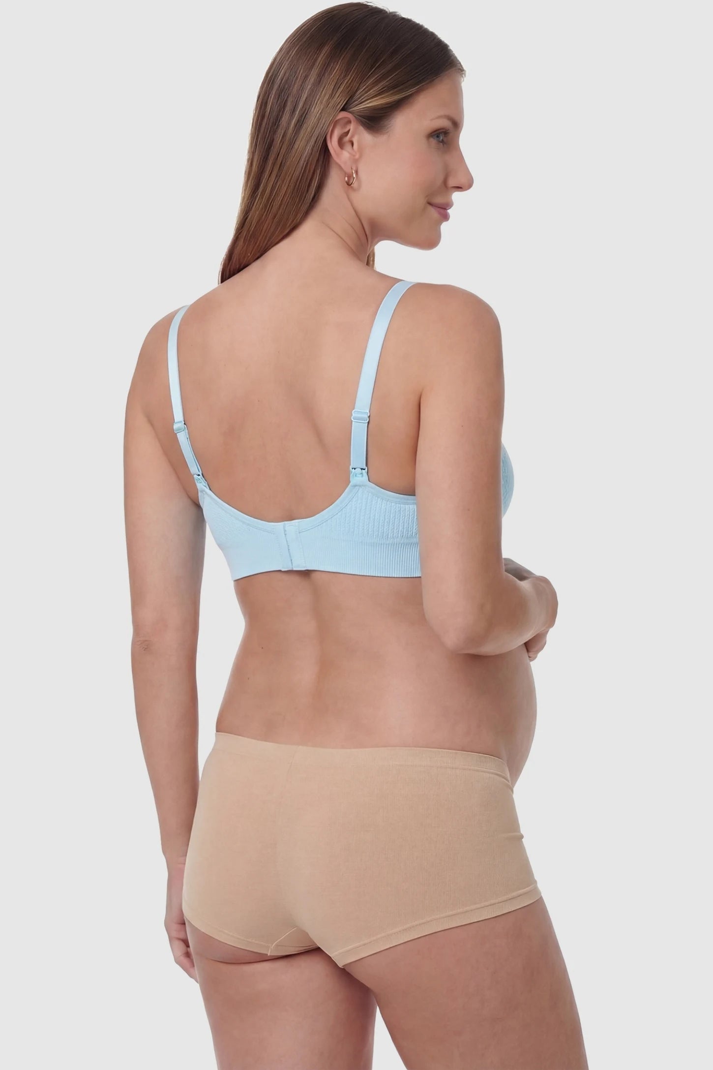 Full-Flap Seamless Top-Opening Nursing Bra Full-flap seamless top-opening nursing bra in light blue with invisible back buckle, back view on pregnant model