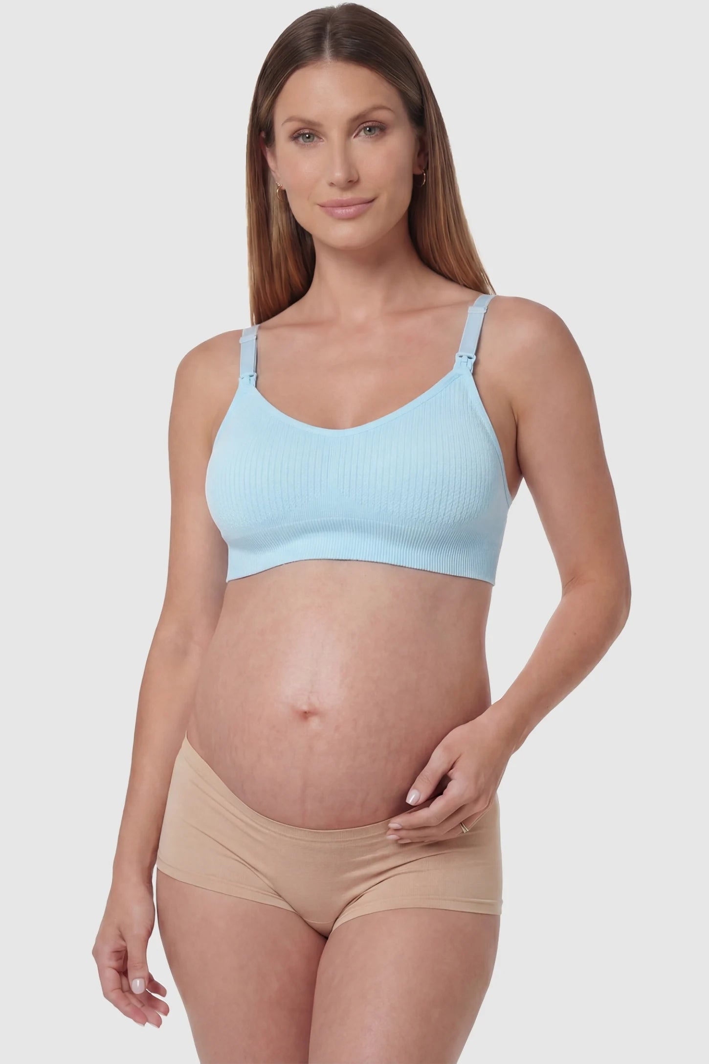 Full-Flap Seamless Top-Opening Nursing Bra Full-flap seamless top-opening nursing bra in light blue with 3D support, front view on pregnant model