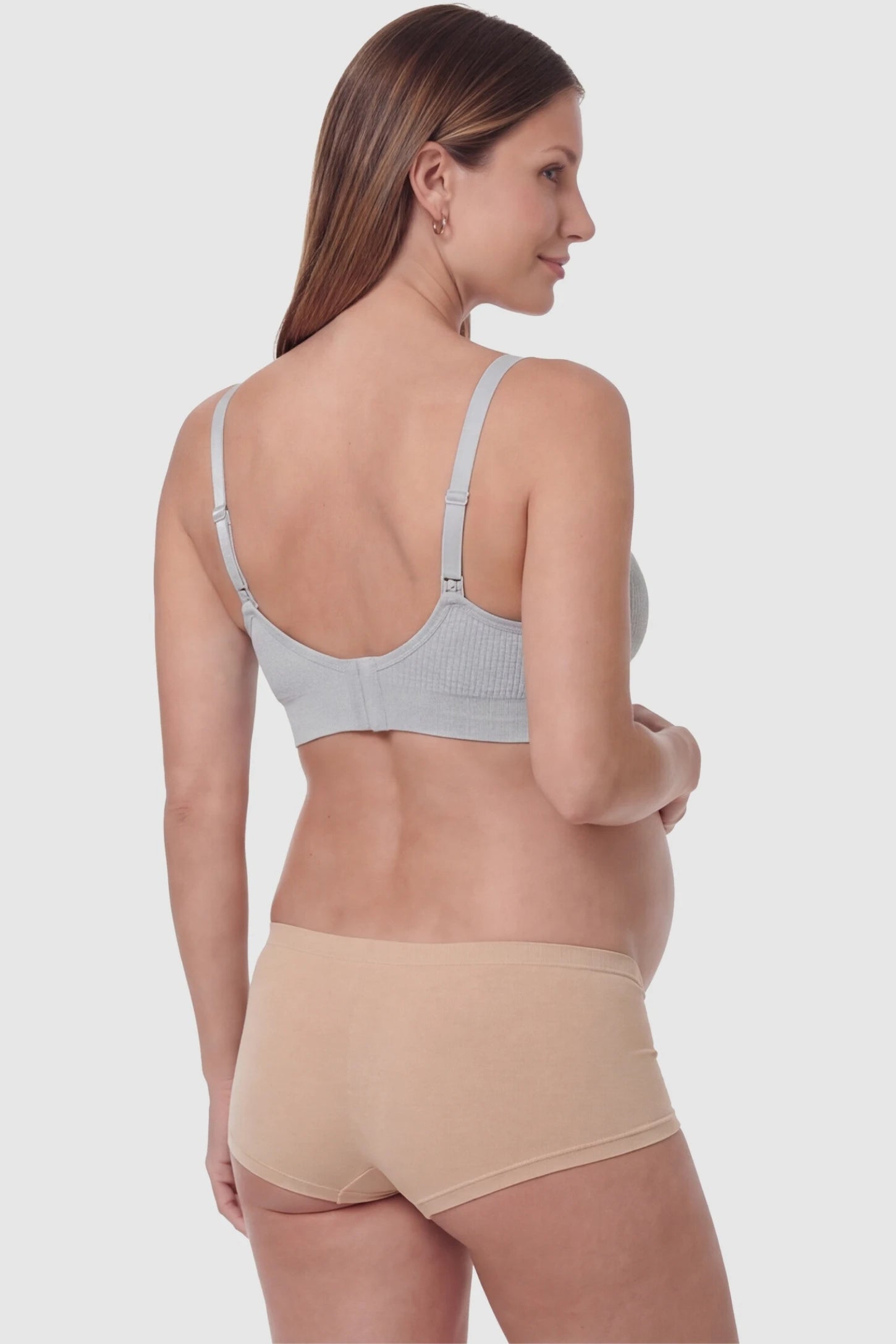 Full-Flap Seamless Top-Opening Nursing Bra Full-flap seamless top-opening nursing bra in light gray with invisible back buckle, back view on pregnant model