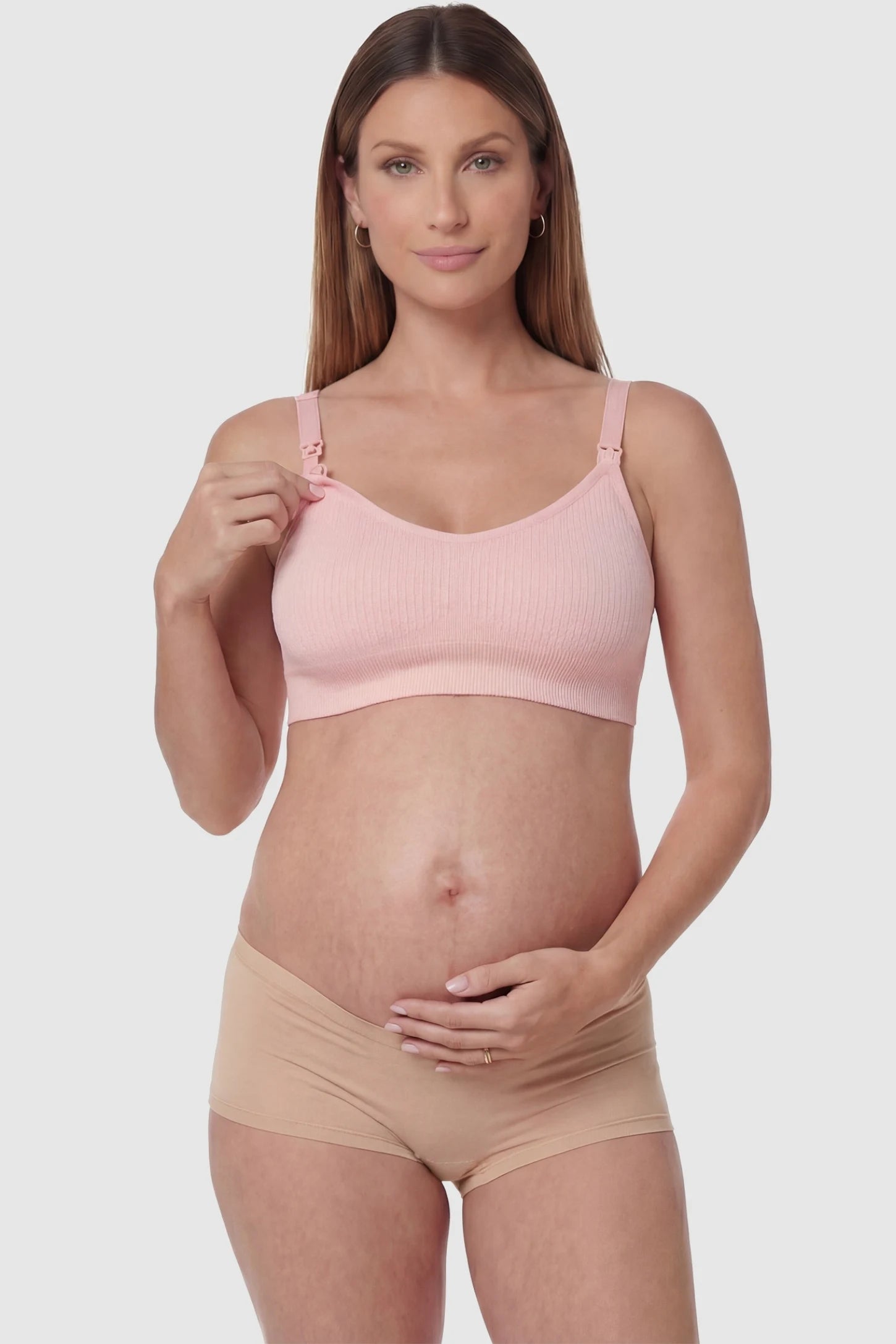 Full-Flap Seamless Top-Opening Nursing Bra Full-flap seamless top-opening nursing bra in light pink with one-hand access, front view on function demo model