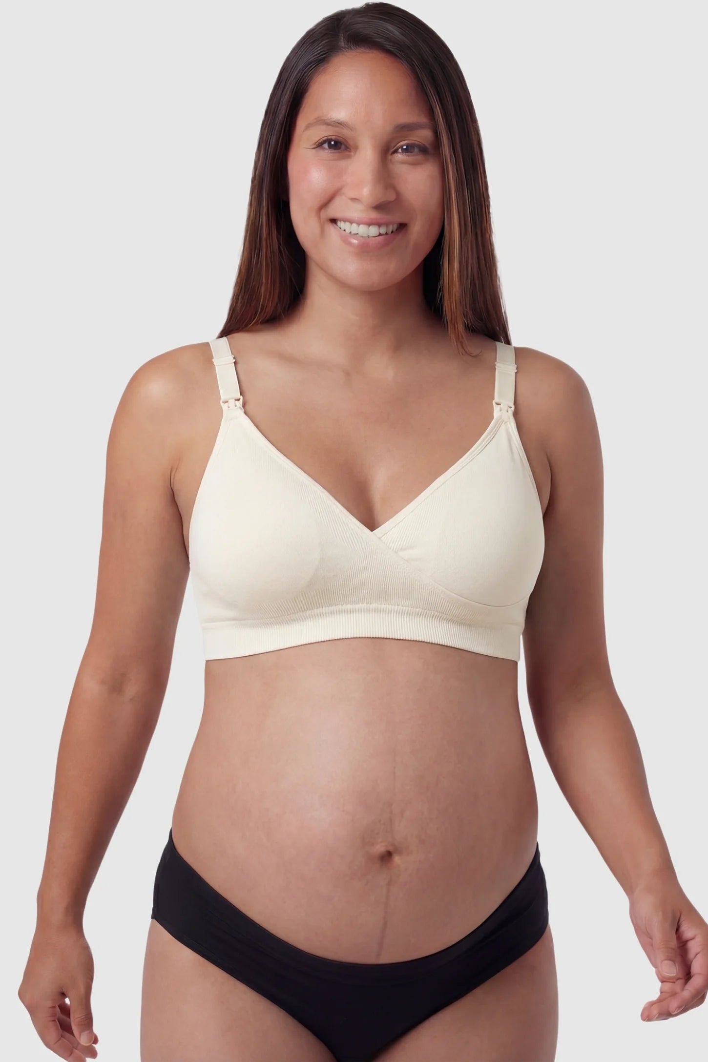 Seamless Front-Open Cross Wireless Nursing Bra Seamless front-open cross wireless nursing bra in nude with cross front access, front view on pregnant model