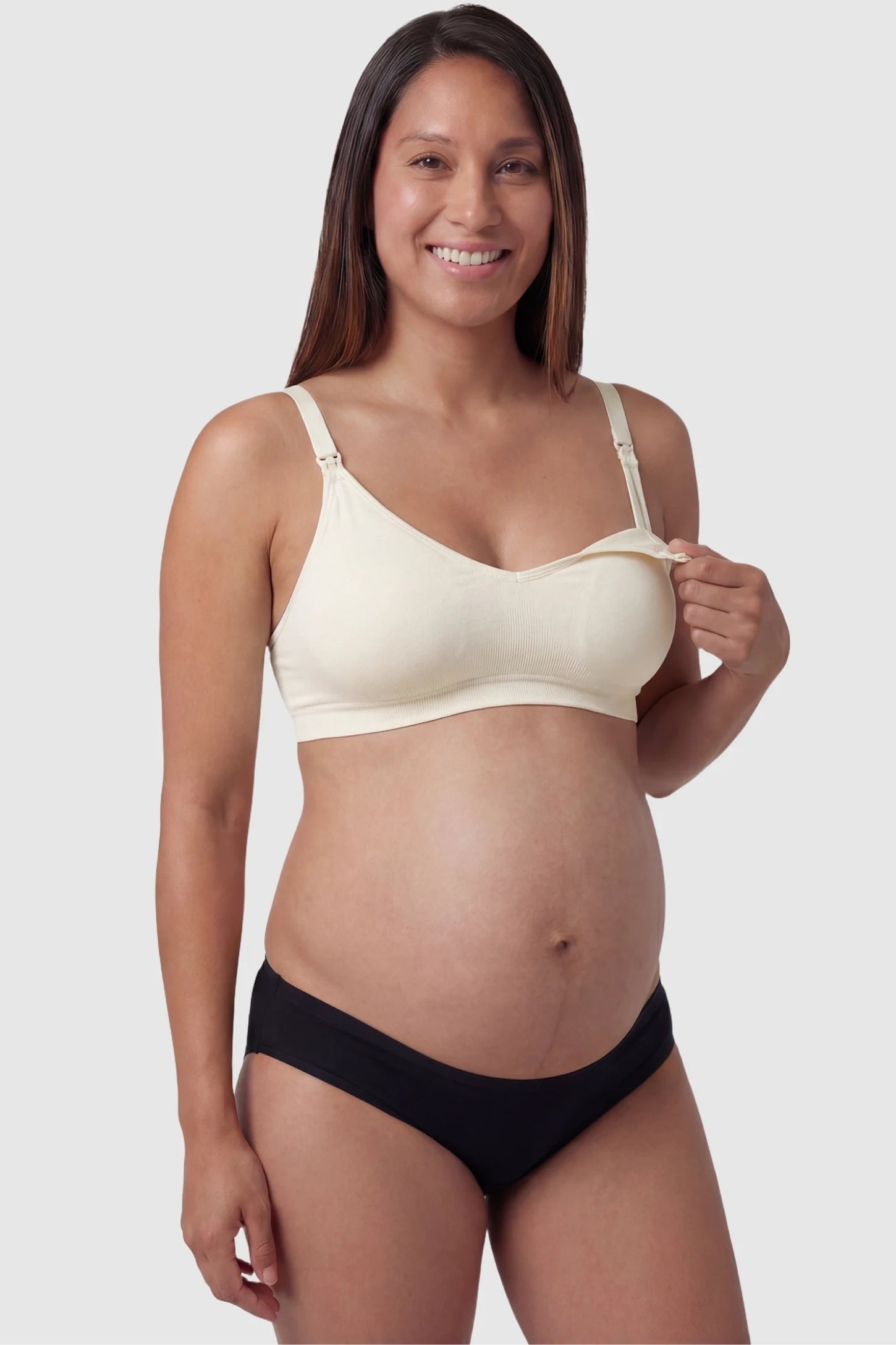 Seamless Front-Open Cross Wireless Nursing Bra Seamless front-open cross wireless nursing bra in nude with front nursing access, front view on pregnant model
