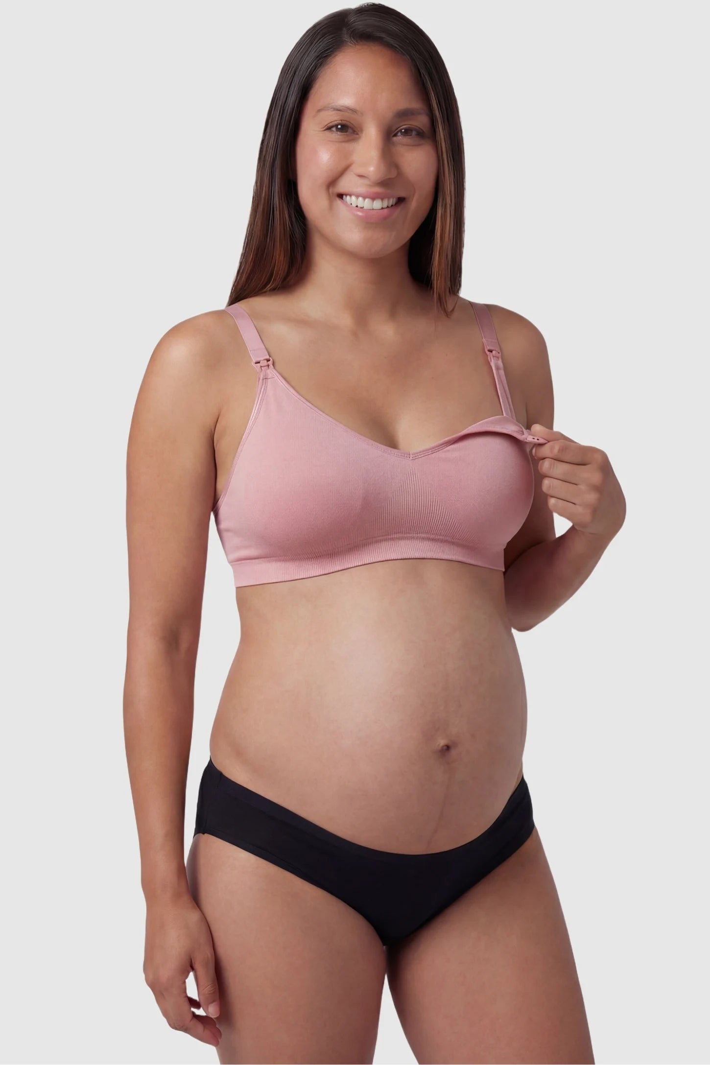 Seamless Front-Open Cross Wireless Nursing Bra Seamless front-open cross wireless nursing bra in peach red with front nursing access, front view on pregnant model