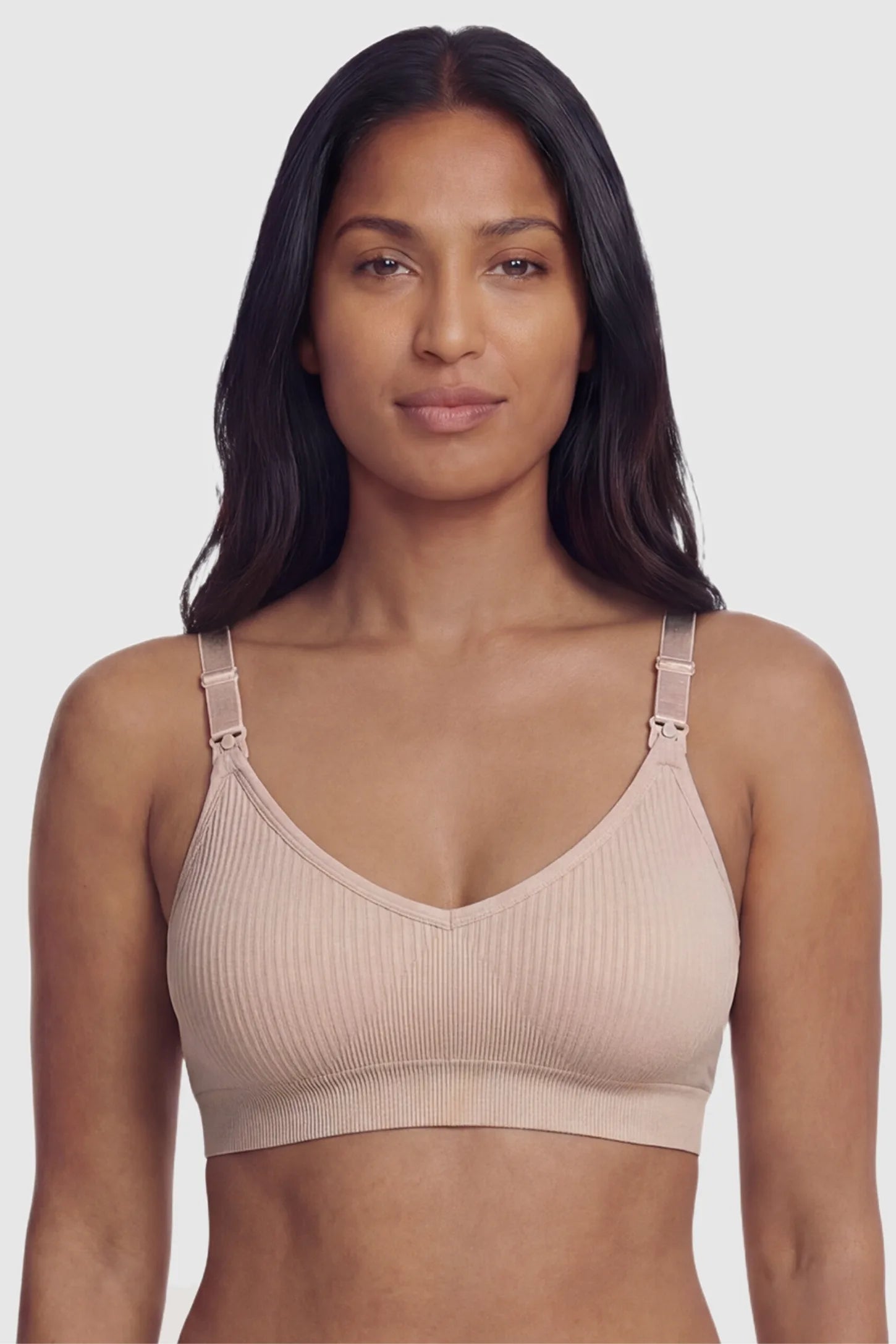 Ribbed Wireless Adjustable Shoulder Strap Nursing Bra Ribbed wireless adjustable strap nursing bra in pink with stretchy fabric, front view on postpartum model