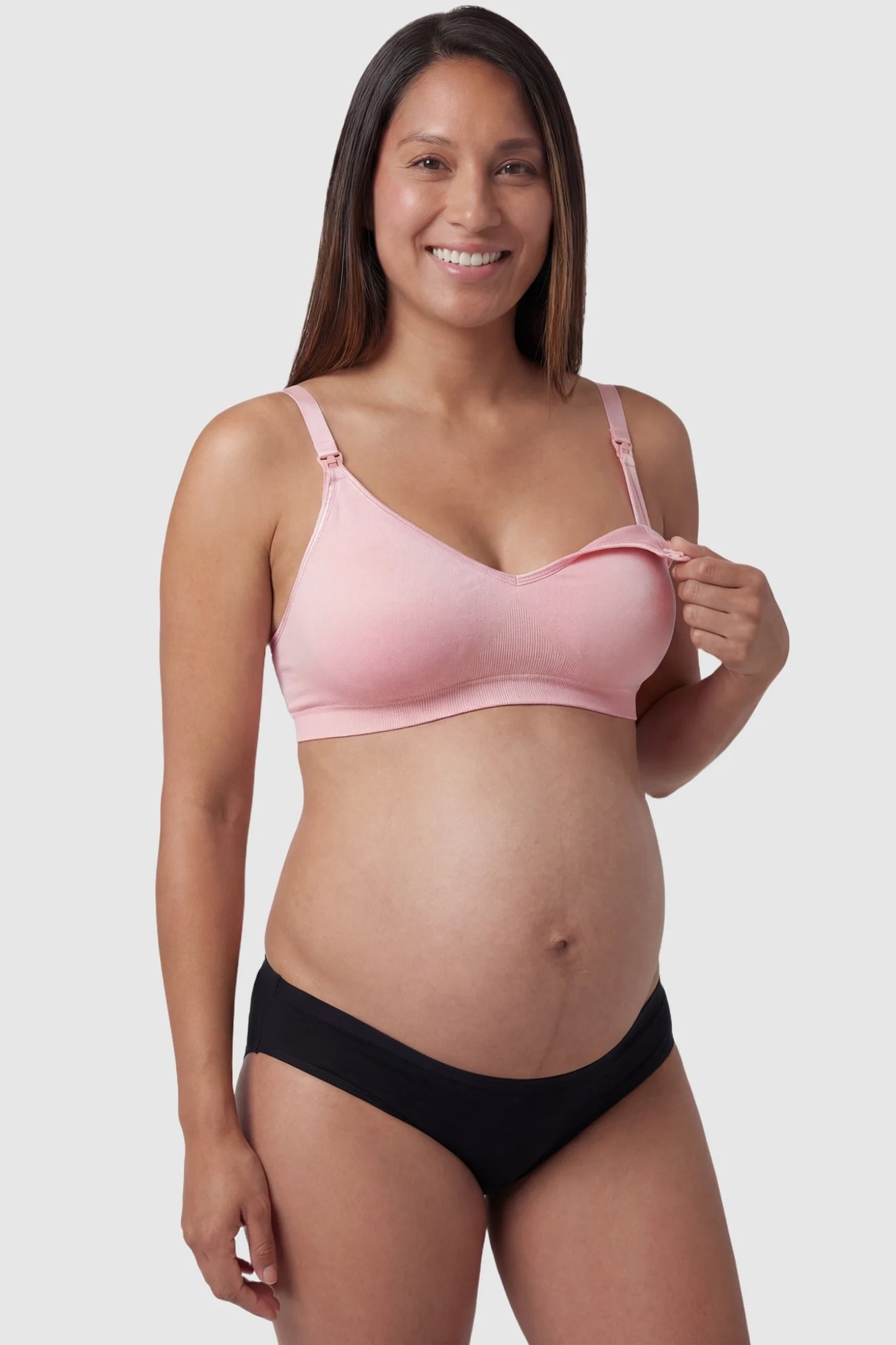 Seamless Front-Open Cross Wireless Nursing Bra Seamless front-open cross wireless nursing bra in pink with front nursing access, front view on pregnant model