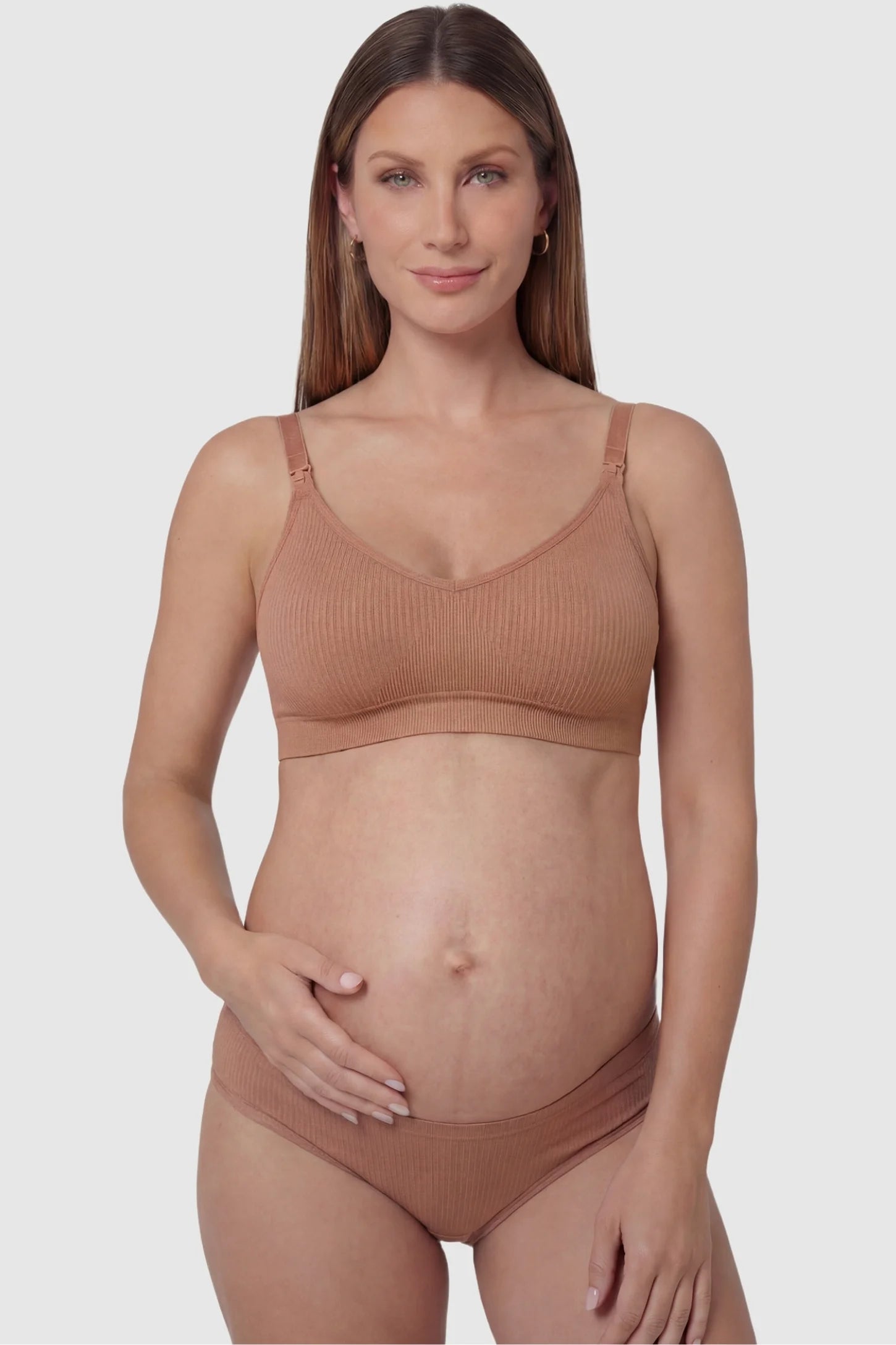 Ribbed Wireless Adjustable Shoulder Strap Nursing Bra Ribbed wireless adjustable strap nursing bra in shrimp red with front clasp, front view on pregnant model