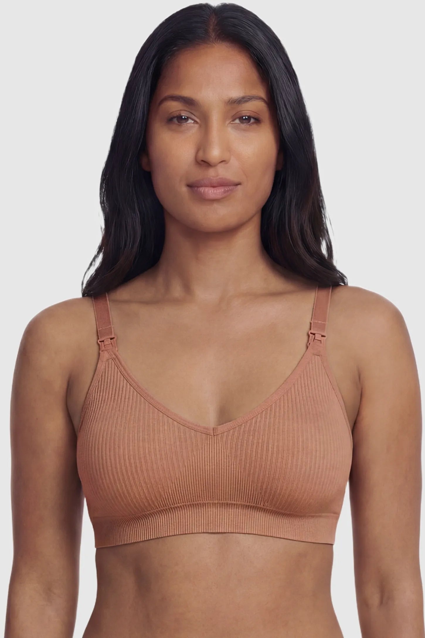 Ribbed Wireless Adjustable Shoulder Strap Nursing Bra Ribbed wireless adjustable strap nursing bra in shrimp red with stretchy fabric, front view on postpartum model