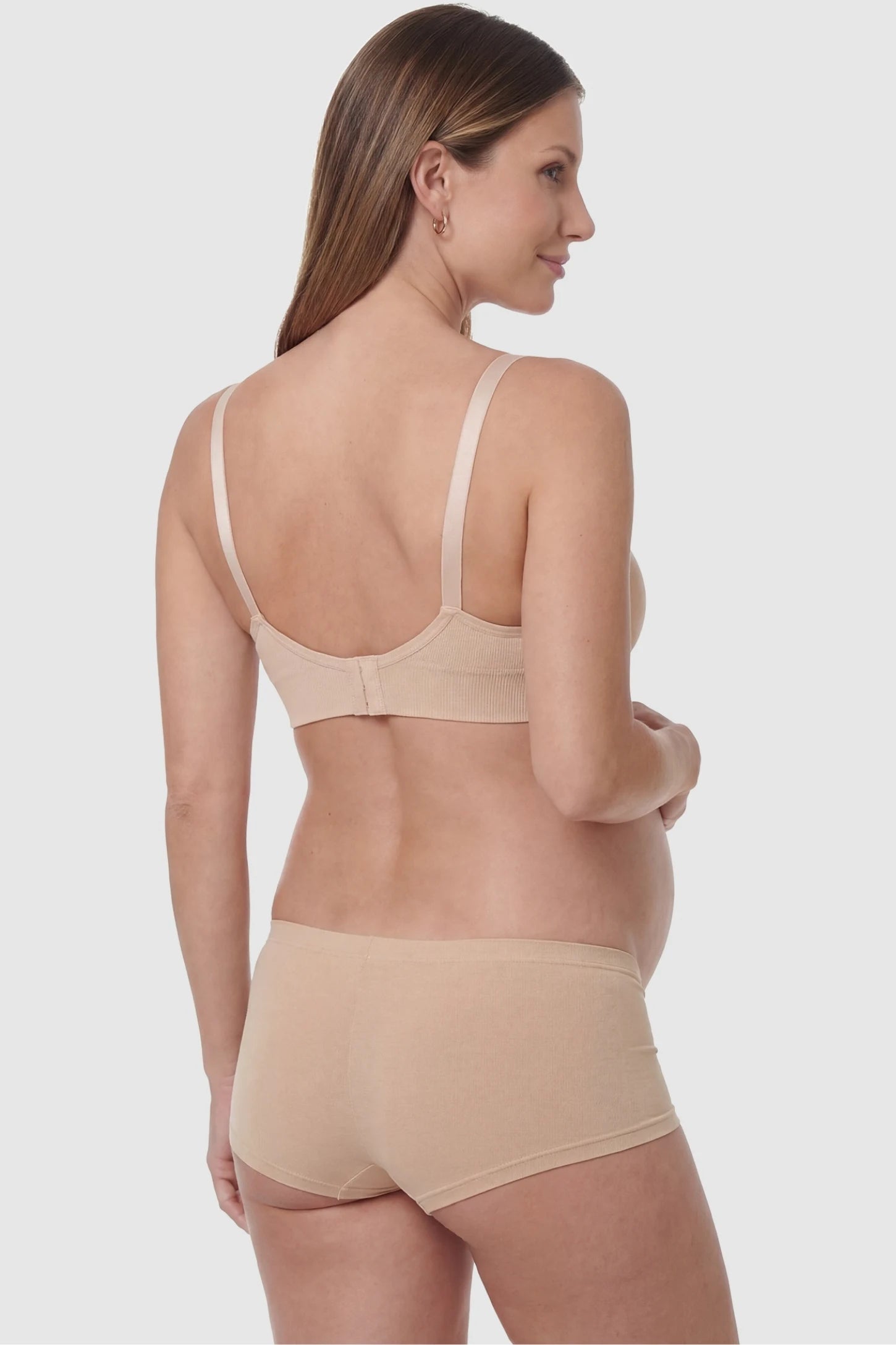 Full-Flap Seamless Top-Opening Nursing Bra Full-flap seamless top-opening nursing bra in skin color with invisible back buckle, back view on pregnant model