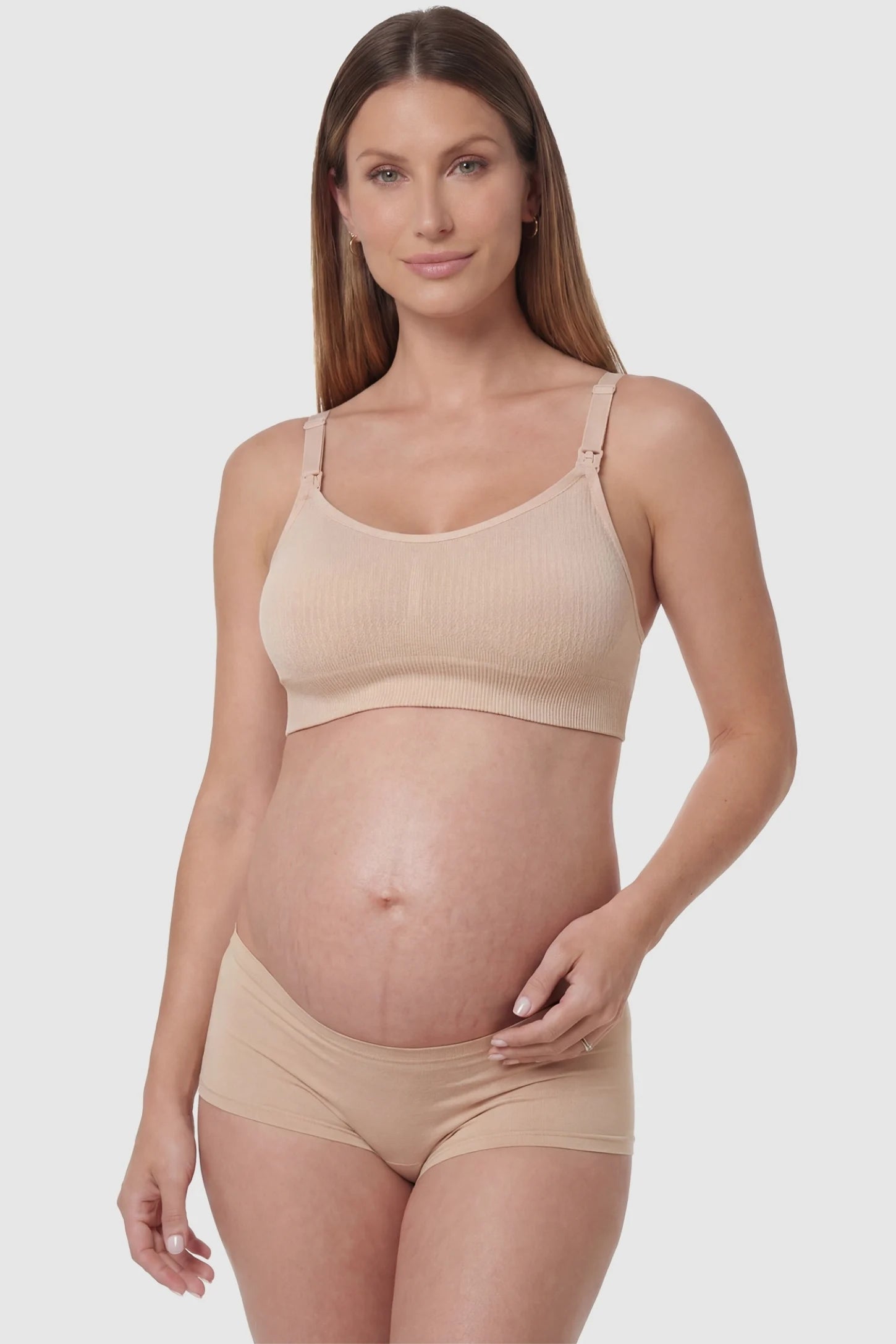 Full-Flap Seamless Top-Opening Nursing Bra Full-flap seamless top-opening nursing bra in skin color with 3D support, front view on pregnant model