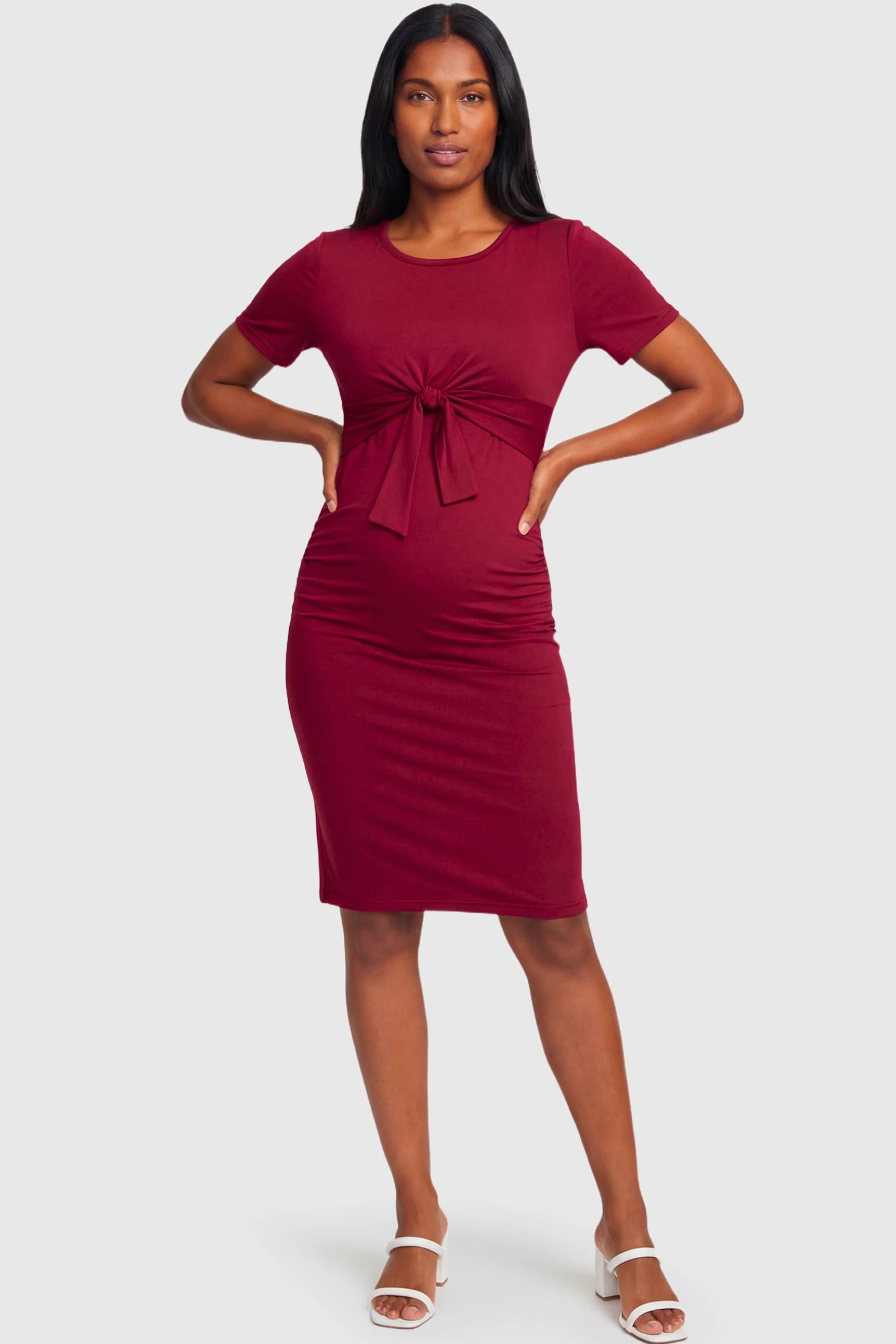 Crew Neck Bodycon Maternity & Nursing Midi Dress Crew Neck Bodycon Maternity & Nursing Midi Dress in wine red featuring twist-front detail and short sleeves on a non pregnant model.
