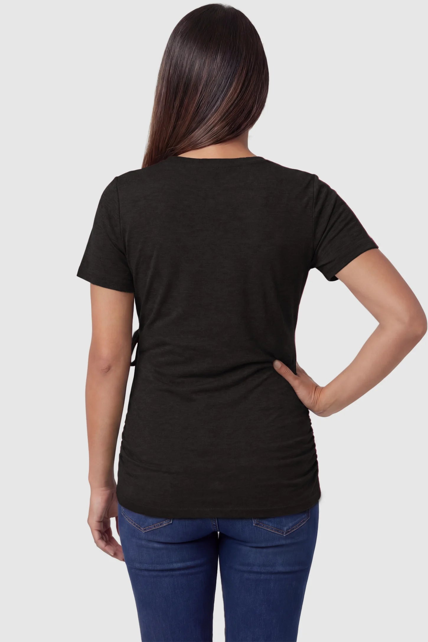 Nursing access V-neck wrap maternity and nursing top in black with short sleeves, back view on pregnant model