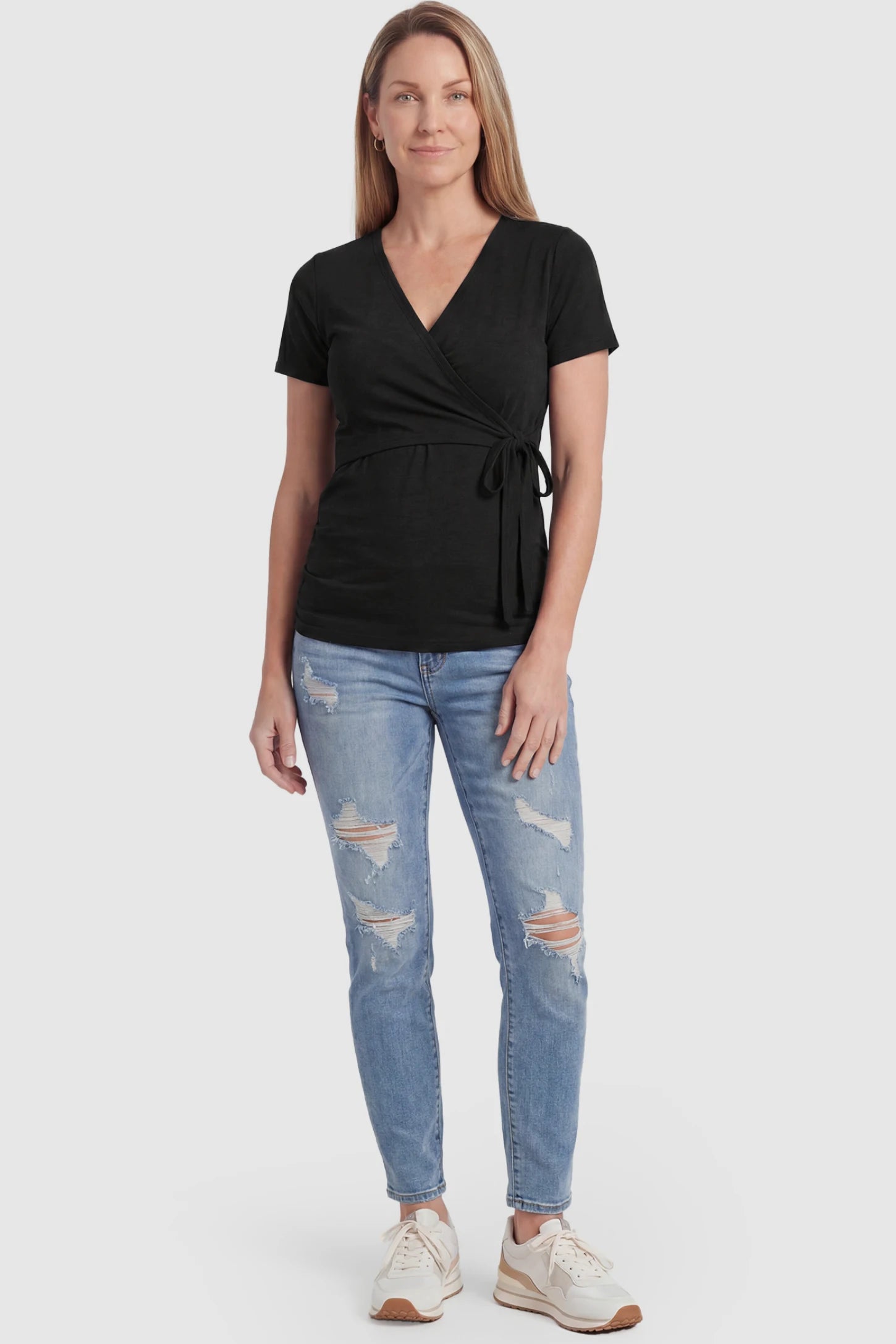 Nursing Access V-Neck Wrap Maternity & Nursing Top Nursing access V-neck wrap maternity and nursing top in black with wrap front and tie detail, front view on postpartum model