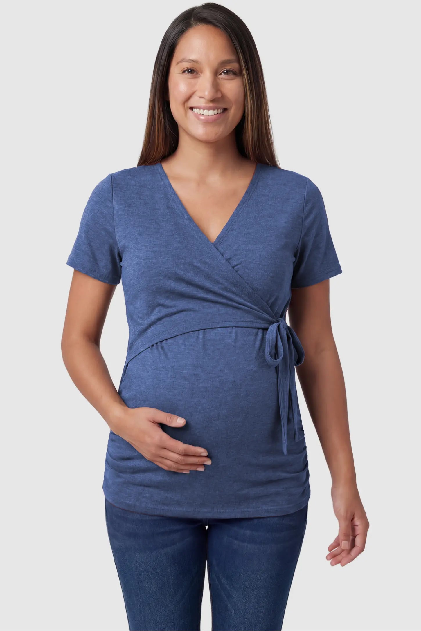 Nursing Access V-Neck Wrap Maternity & Nursing Top Nursing access V-neck wrap maternity and nursing top in blue with wrap front and tie detail, front view on pregnant model