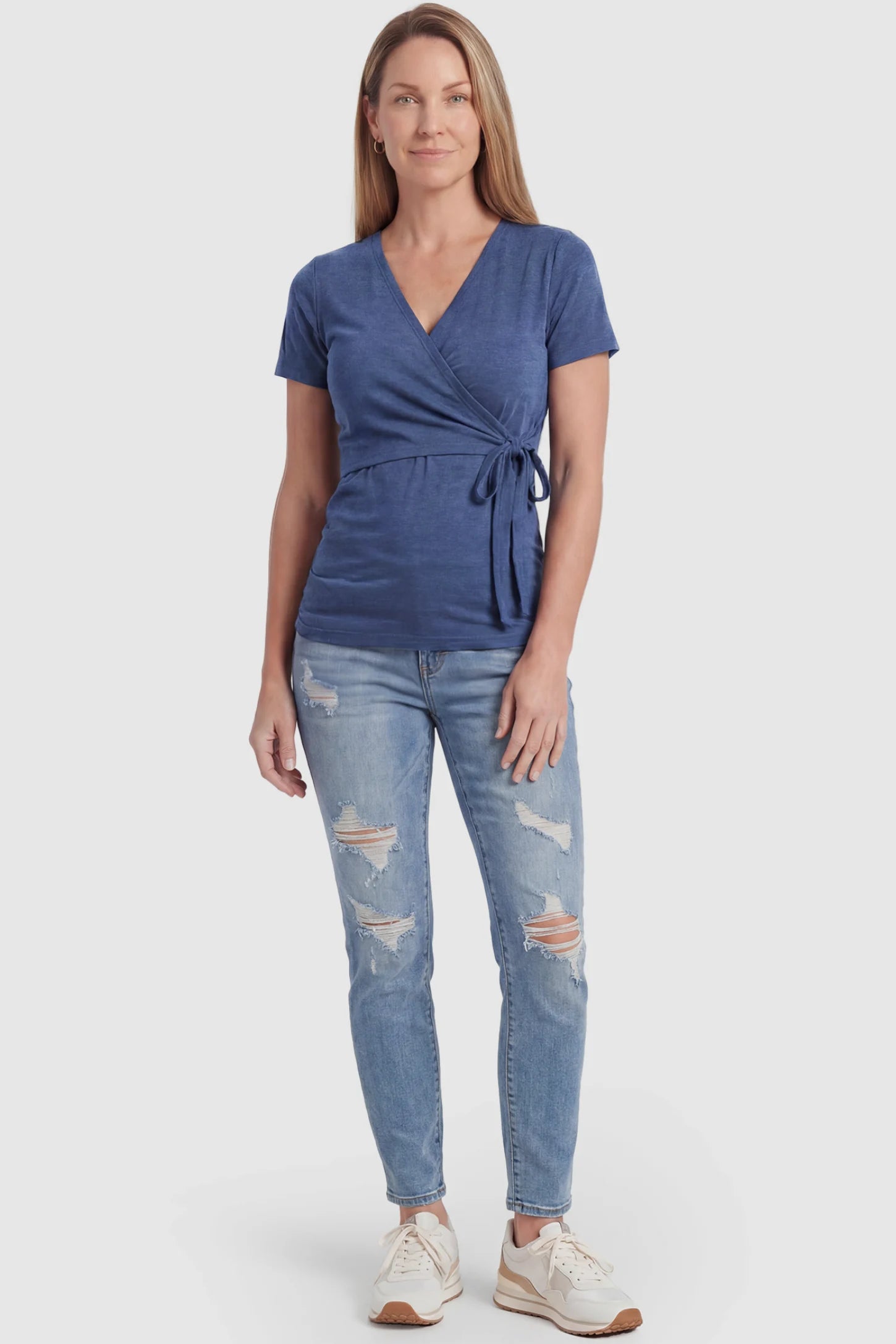 Nursing Access V-Neck Wrap Maternity & Nursing Top Nursing access V-neck wrap maternity and nursing top in blue with wrap front and tie detail, front view on postpartum model