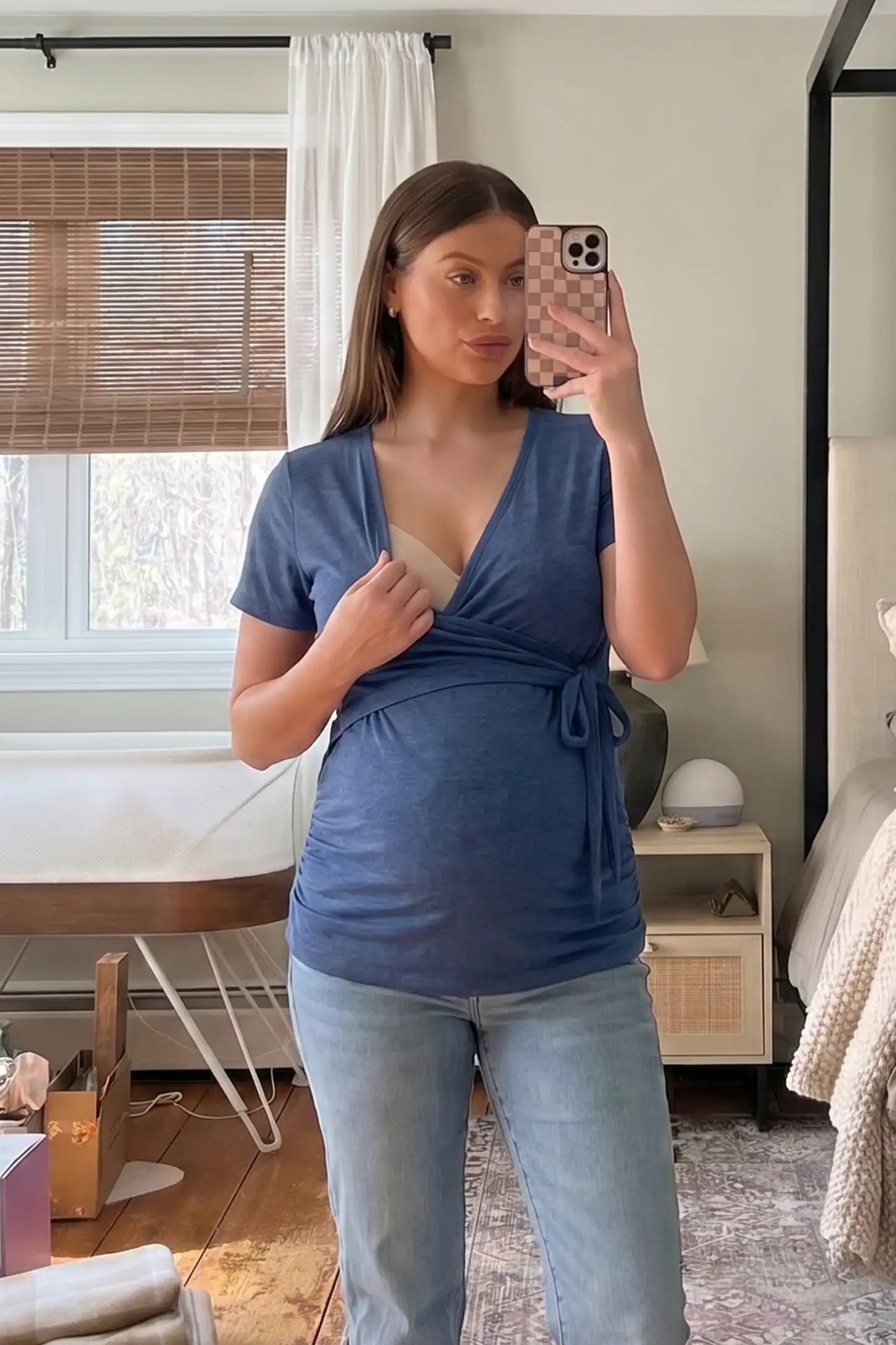 Nursing Access V-Neck Wrap Maternity & Nursing Top Nursing access V-neck wrap maternity and nursing top in blue with easy nursing access design, front view on pregnant model