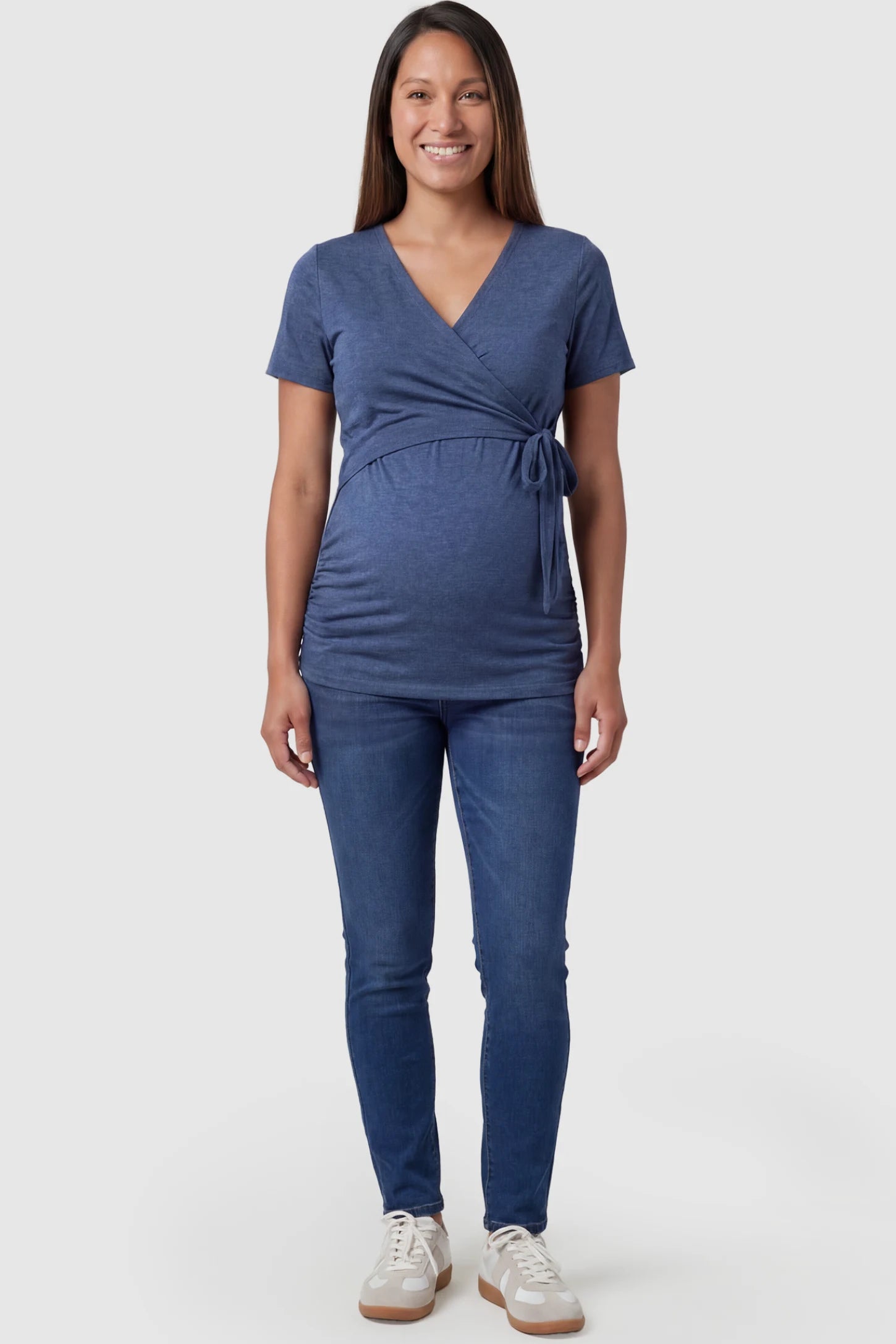 Nursing Access V-Neck Wrap Maternity & Nursing Top Nursing access V-neck wrap maternity and nursing top in blue with wrap front and tie detail, front view on pregnant model