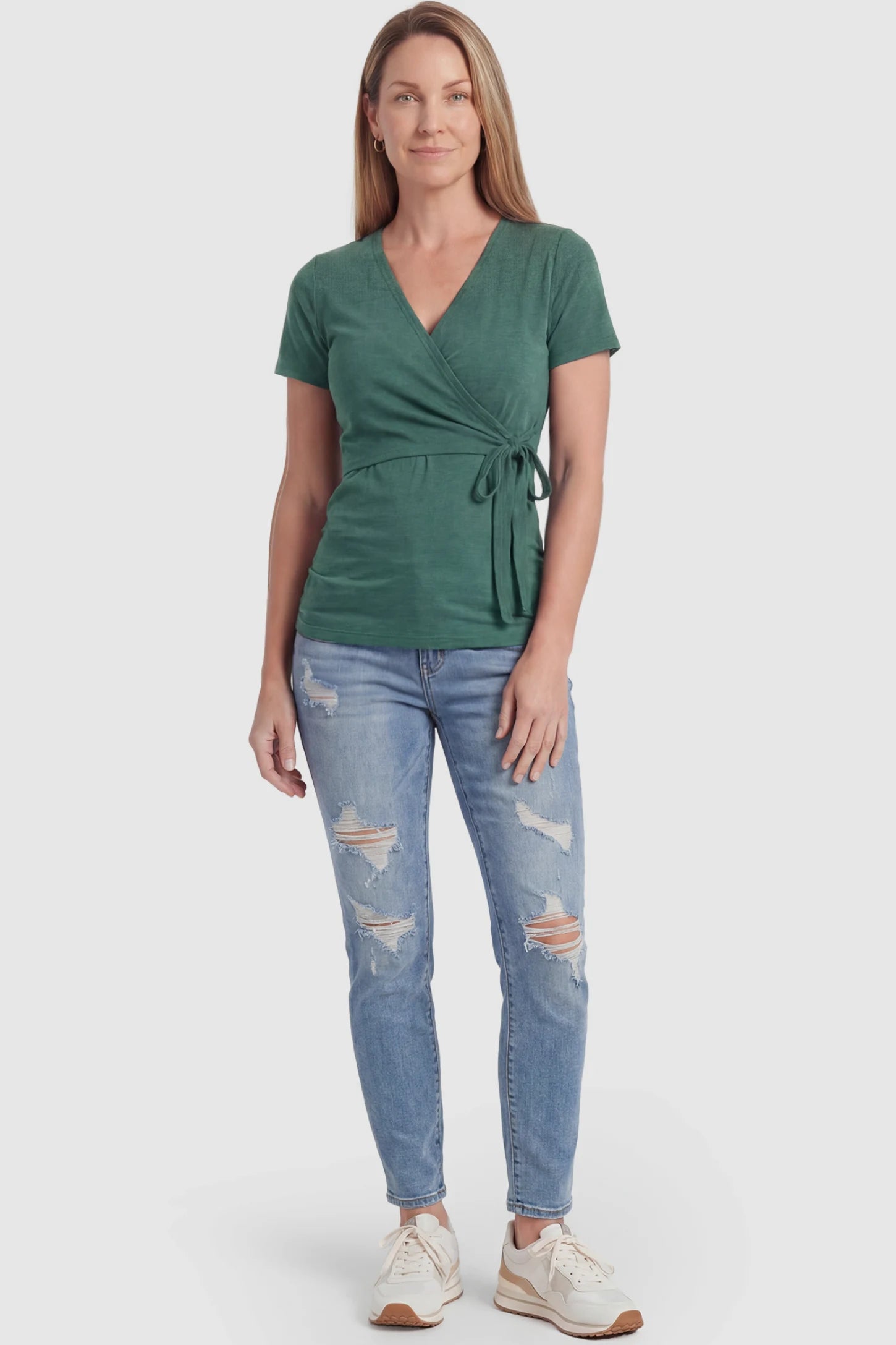 Nursing Access V-Neck Wrap Maternity & Nursing Top Nursing access V-neck wrap maternity and nursing top in green with wrap front and tie detail, front view on postpartum model