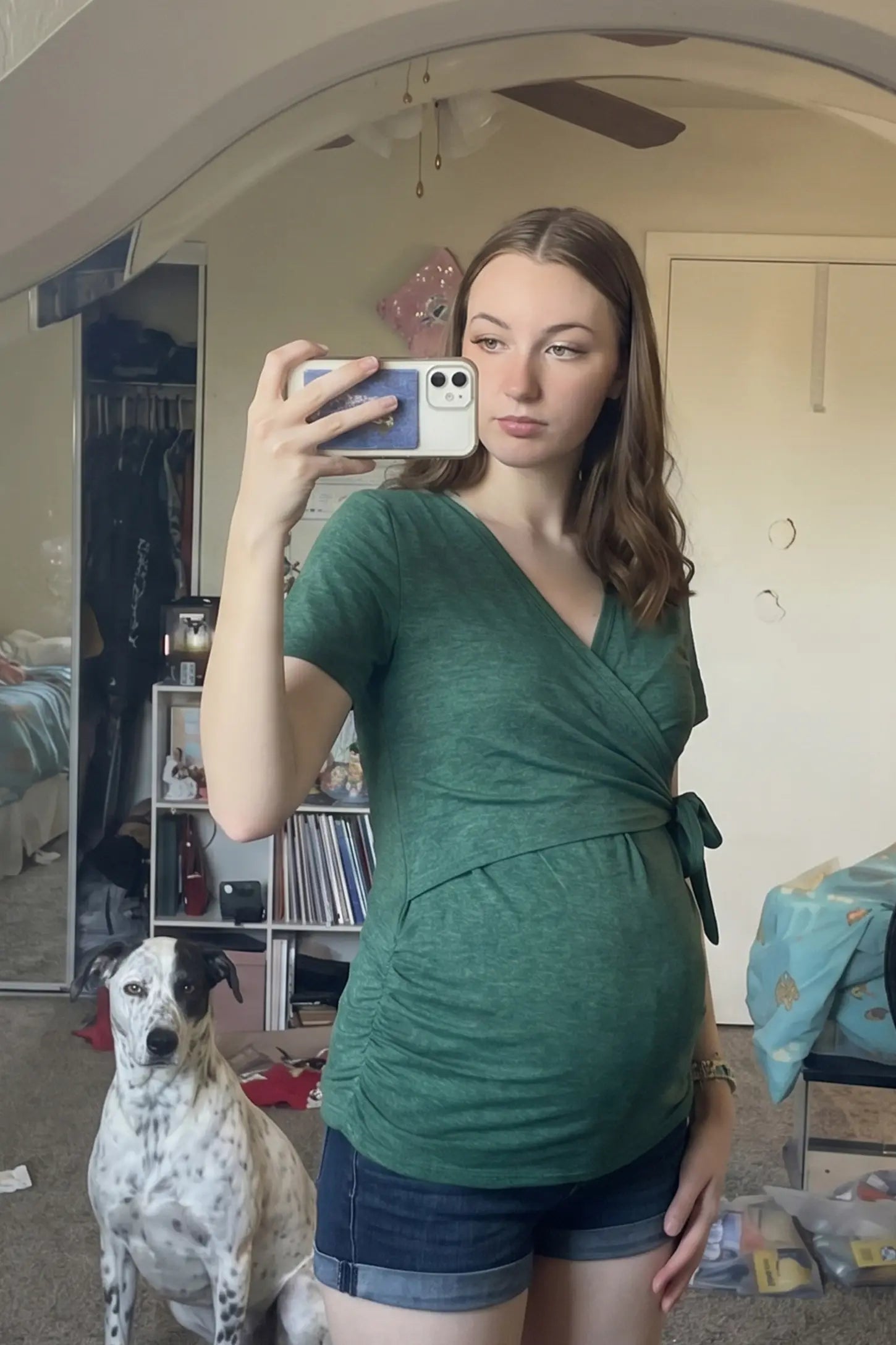 Nursing Access V-Neck Wrap Maternity & Nursing Top Nursing access V-neck wrap maternity and nursing top in green with wrap front and tie detail, front view on pregnant model