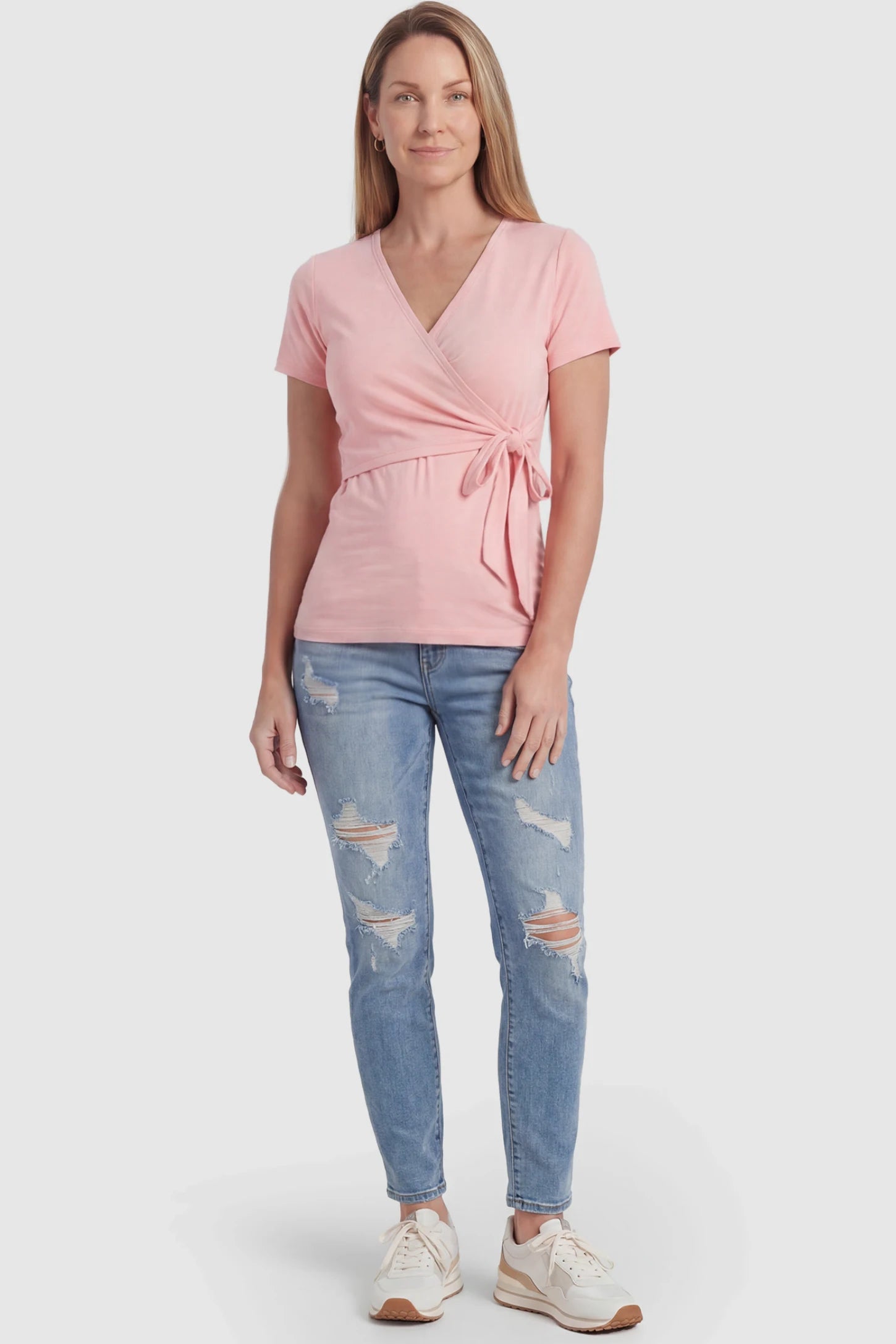 Nursing Access V-Neck Wrap Maternity & Nursing Top Nursing access V-neck wrap maternity and nursing top in pink with wrap front and tie detail, front view on postpartum model