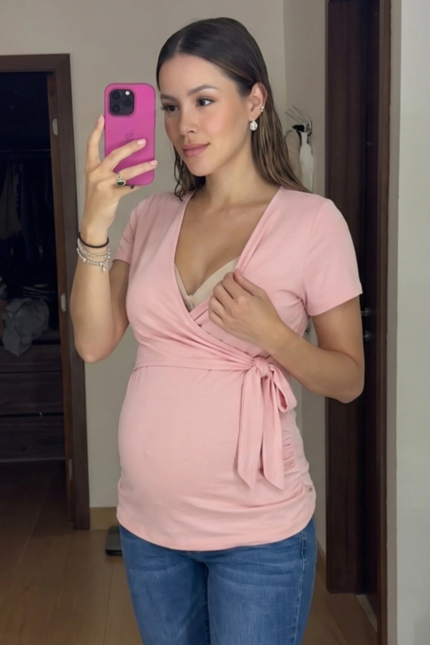 Nursing Access V-Neck Wrap Maternity & Nursing Top Nursing access V-neck wrap maternity and nursing top in pink with easy nursing access design, front view on pregnant model