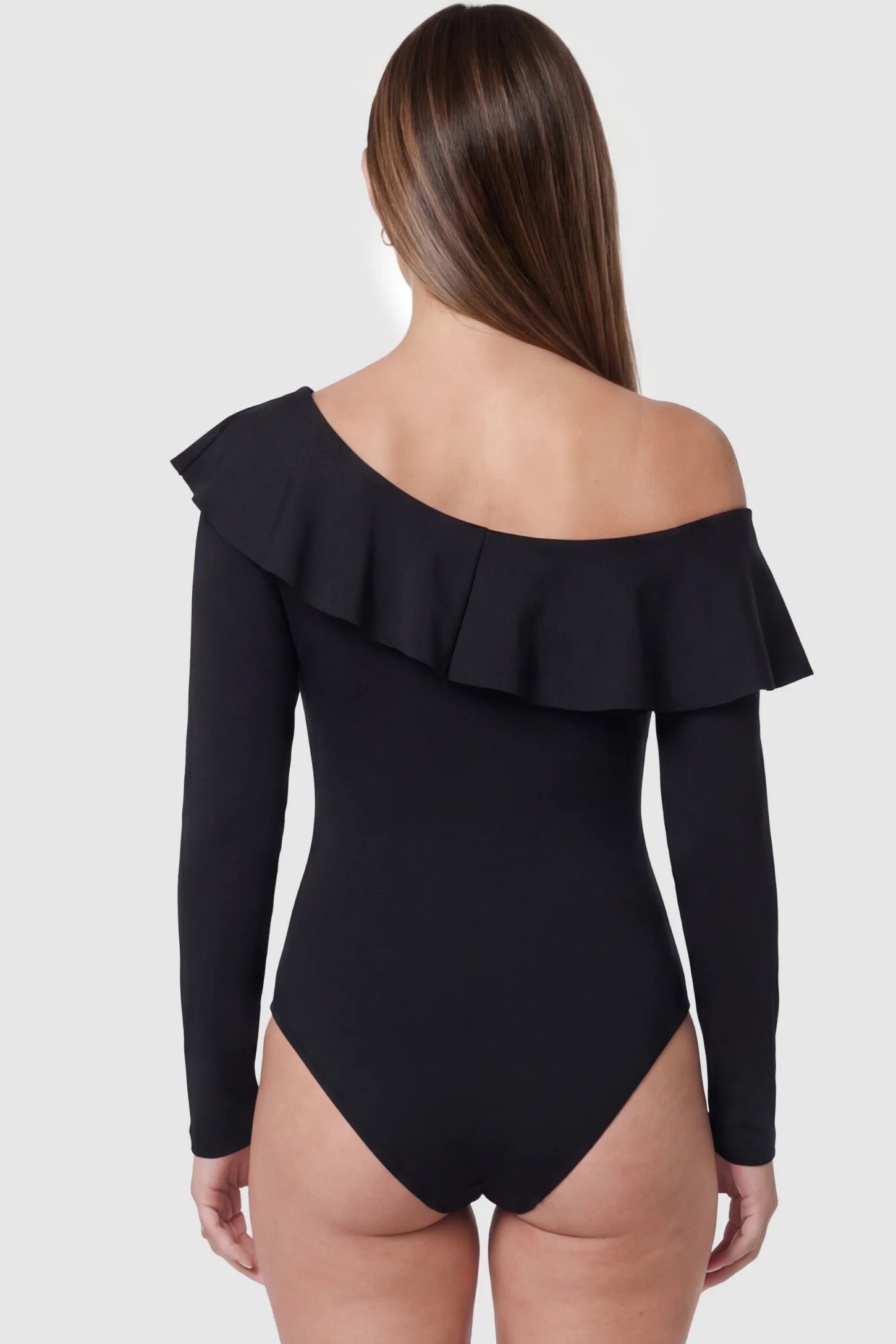 Ruffled Off-Shoulder Bodycon Fit Maternity Photography Bodysuit Ruffled Off-Shoulder Bodycon Fit Maternity Photography Bodysuit in black featuring dramatic ruffled neckline and long sleeves on a pregnant model