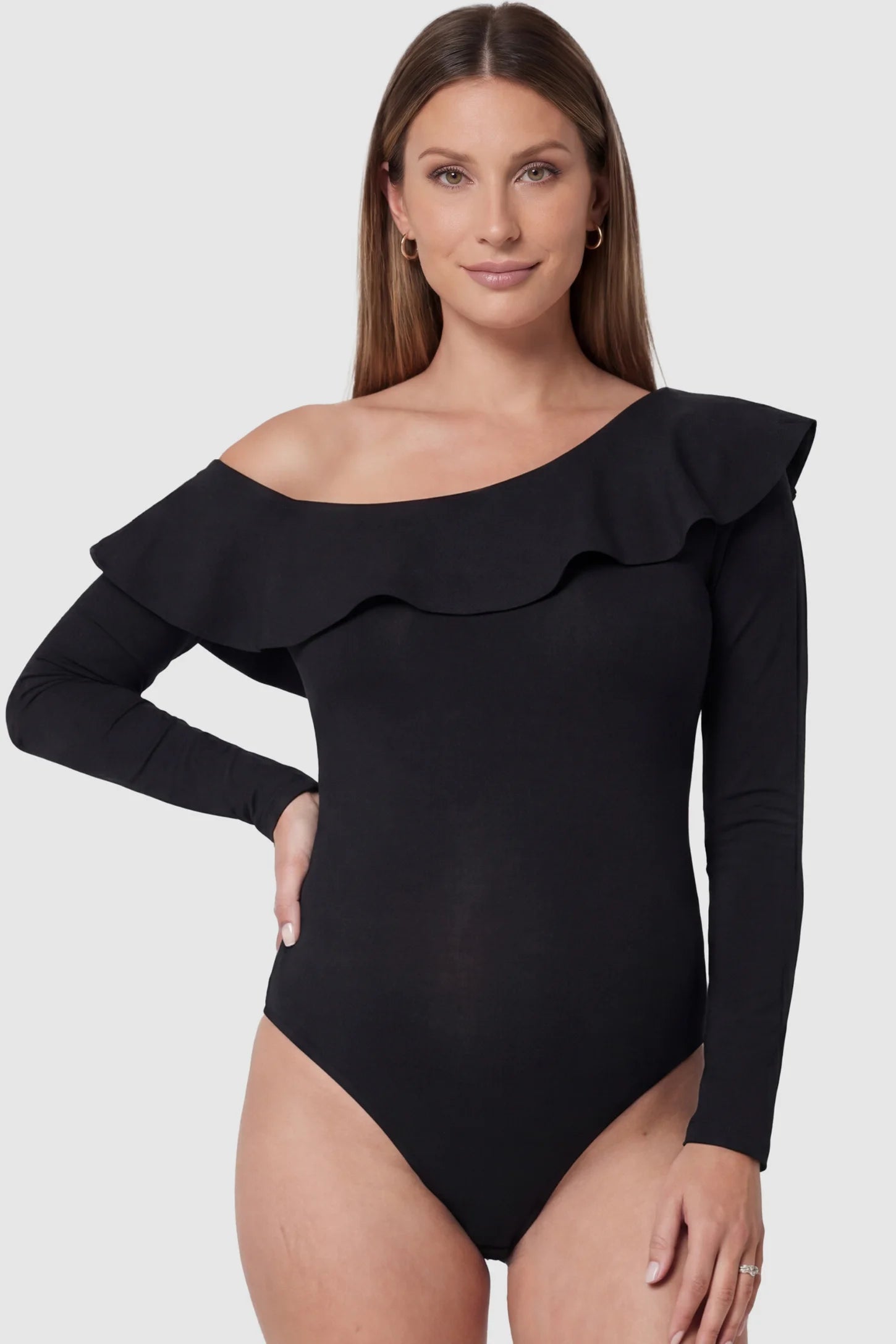 Ruffled Off-Shoulder Bodycon Fit Maternity Photography Bodysuit in black featuring dramatic ruffled neckline and long sleeves on a pregnant model