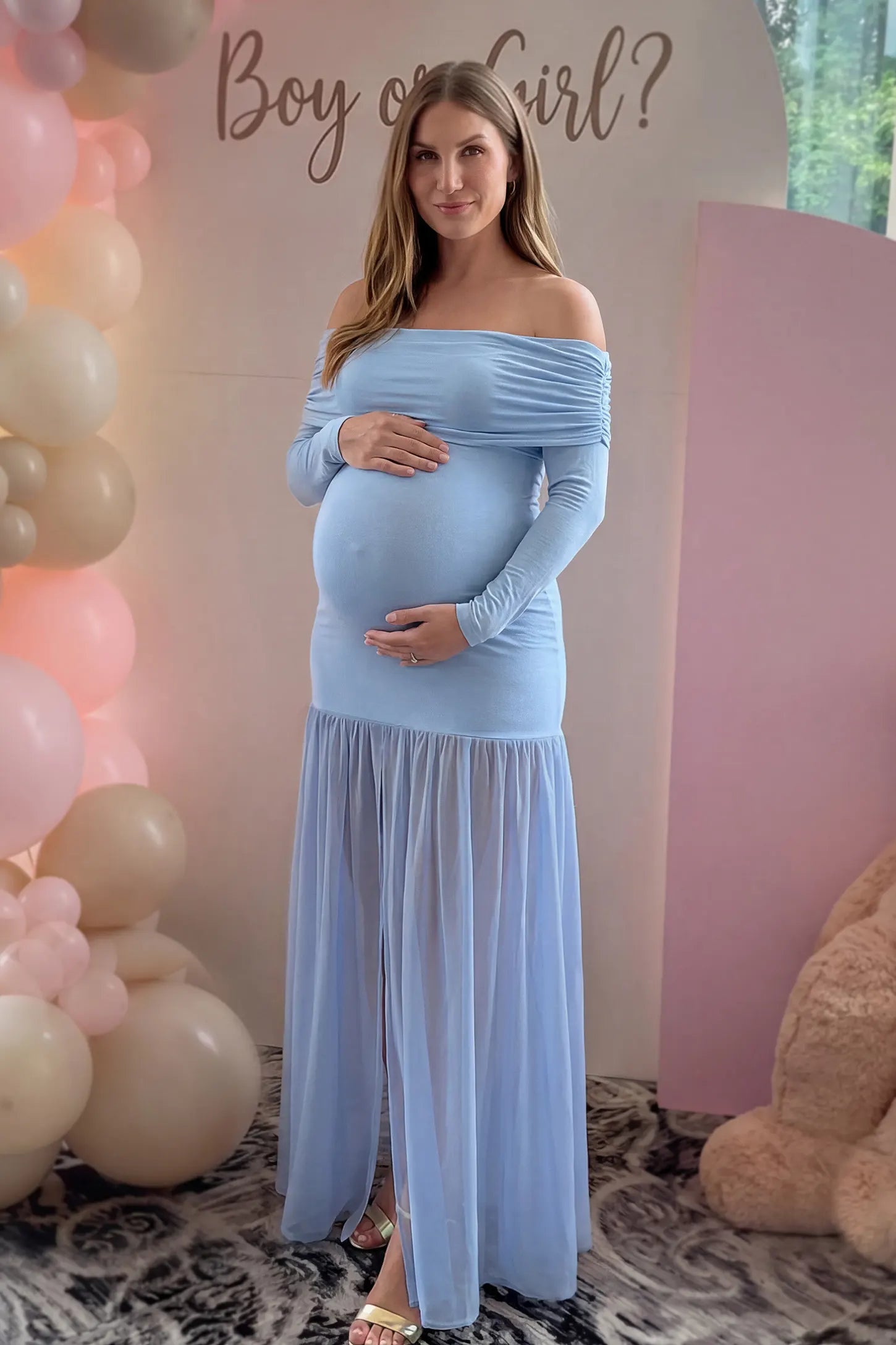 Off-Shoulder Side Ruched Mermaid Maternity Maxi Dress Off-shoulder side ruched mermaid maternity maxi dress in blue with off-shoulder neckline and front slit, front view on pregnant model