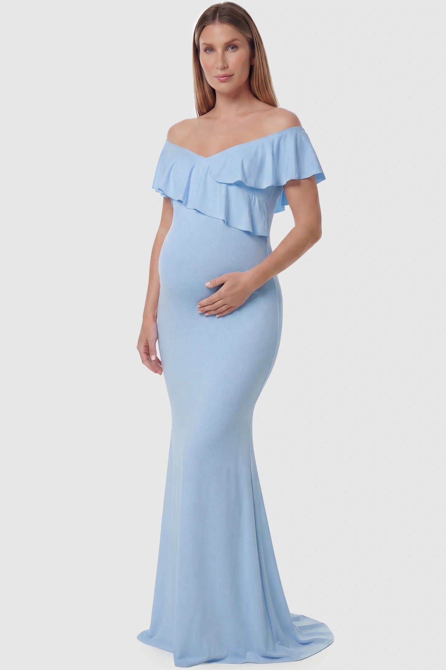 Ruffle Off-Shoulder Slim Fit Maxi Maternity Dress Ruffle off-shoulder slim fit maxi maternity dress in light blue featuring elegant ruffle detailing in front view on a pregnant model