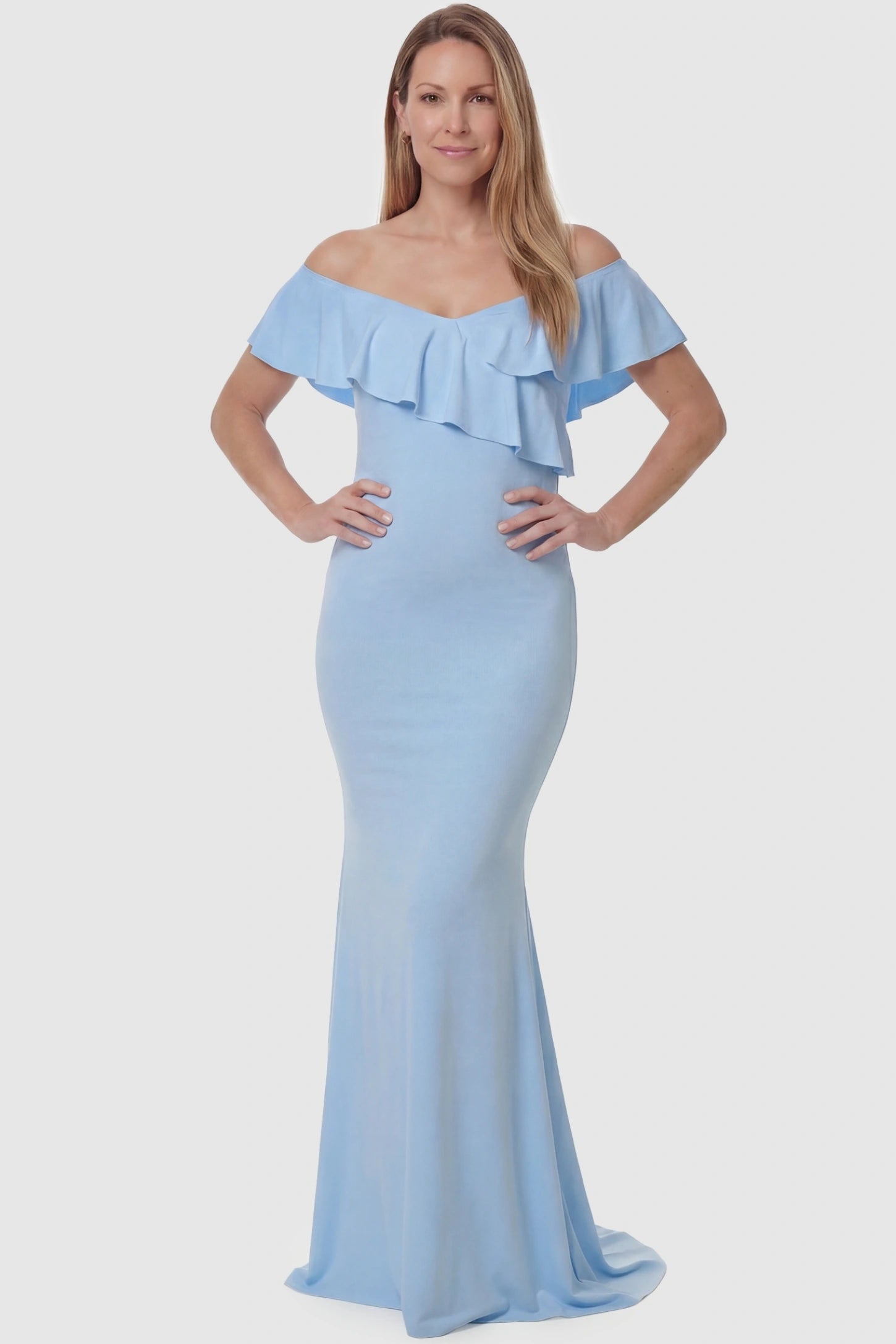 Ruffle Off-Shoulder Slim Fit Maxi Maternity Dress Ruffle off-shoulder slim fit maxi maternity dress in light blue featuring curve-flattering silhouette in full body view on a postpartum model