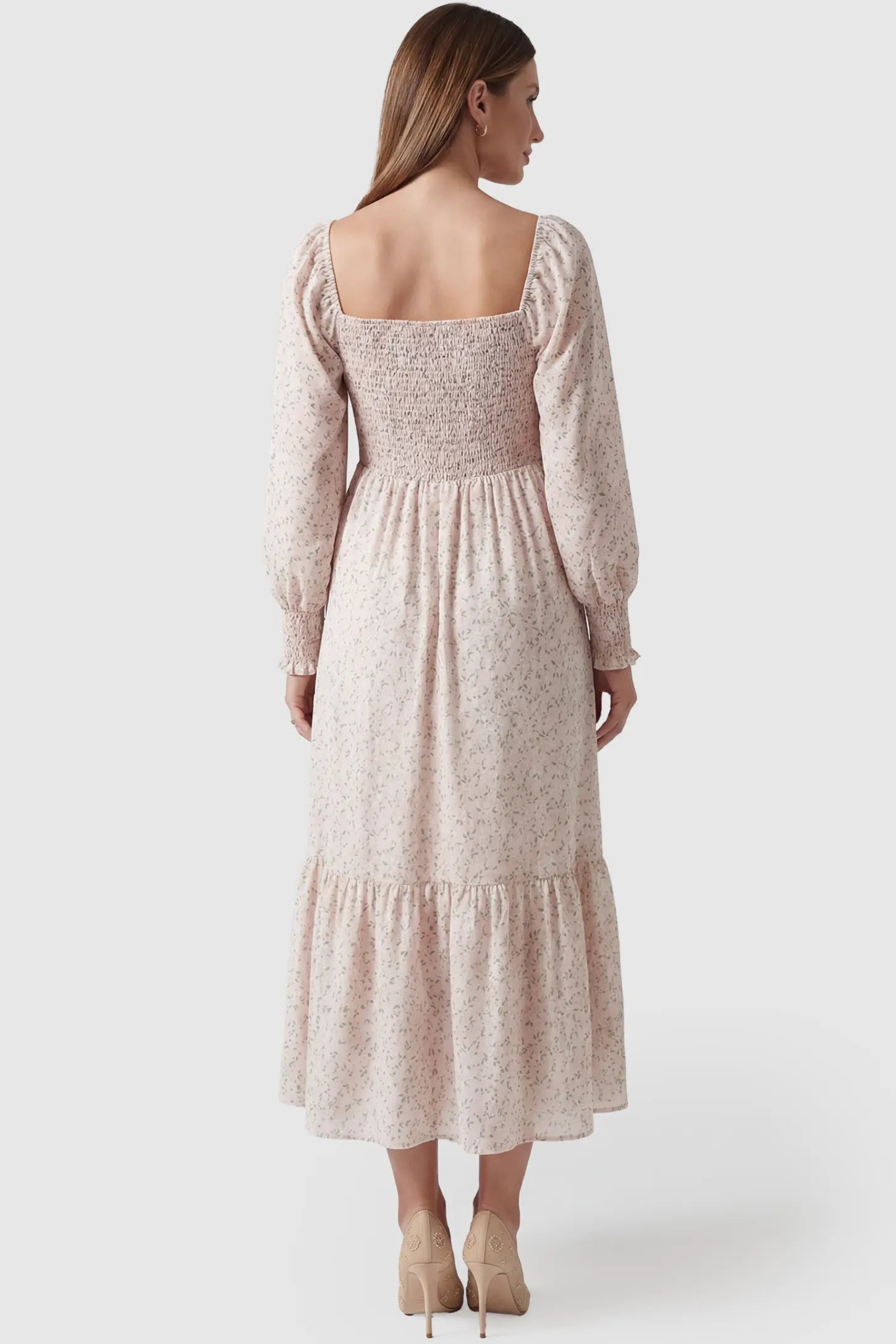 Floral Smocked Tiered Maternity Midi Dress Floral Smocked Tiered Maternity Midi Dress in soft pink floral print featuring square neckline, puff sleeves, and tiered midi skirt on pregnant model.