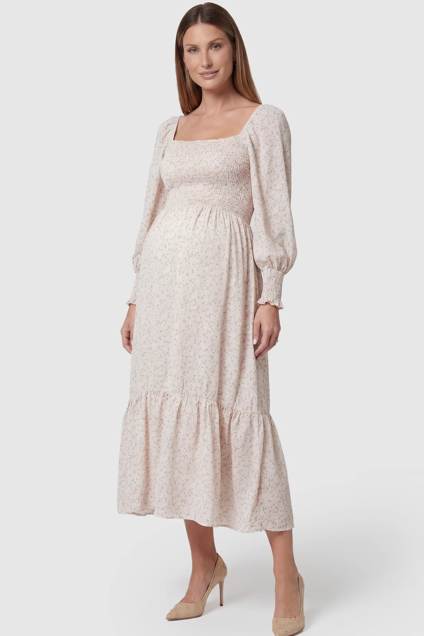 Floral Smocked Tiered Maternity Midi Dress in soft pink floral print featuring square neckline, puff sleeves, and tiered midi skirt on pregnant model.