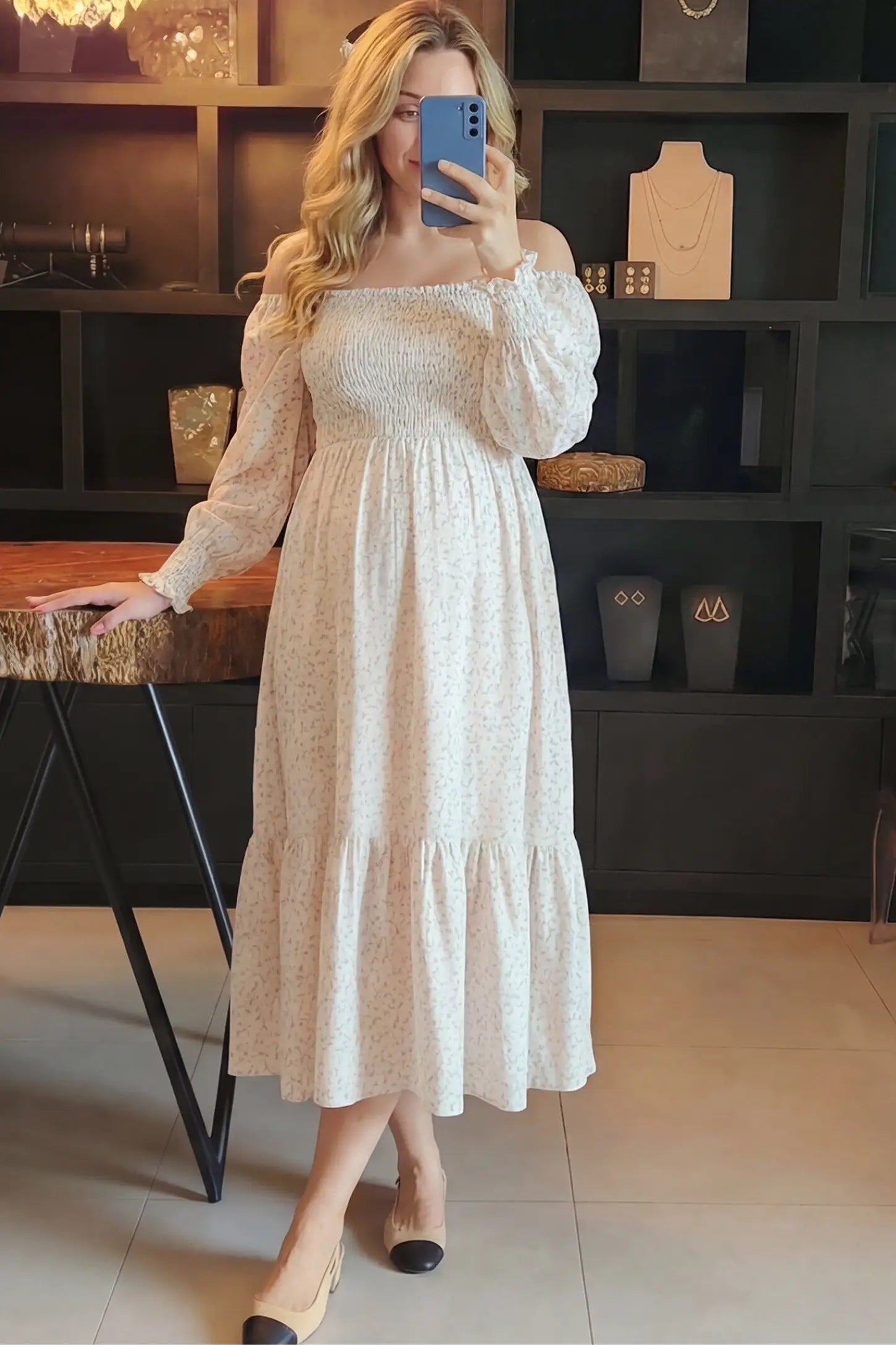 Floral Smocked Tiered Maternity Midi Dress Floral Smocked Tiered Maternity Midi Dress in soft pink floral print featuring square neckline, puff sleeves, and tiered midi skirt on pregnant model.