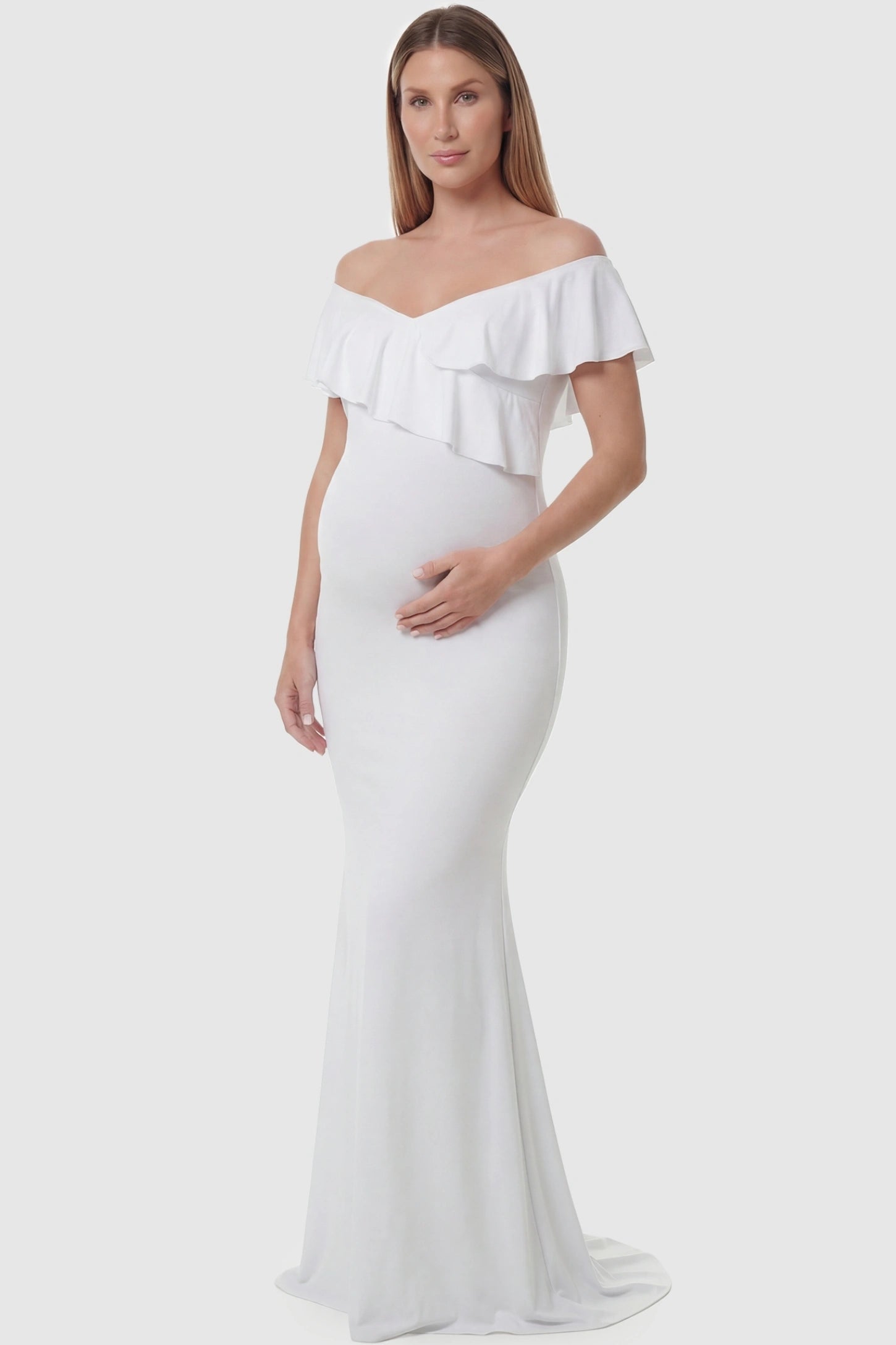 Ruffle off-shoulder slim fit maxi maternity dress in white featuring elegant ruffle detailing in front view on a pregnant model