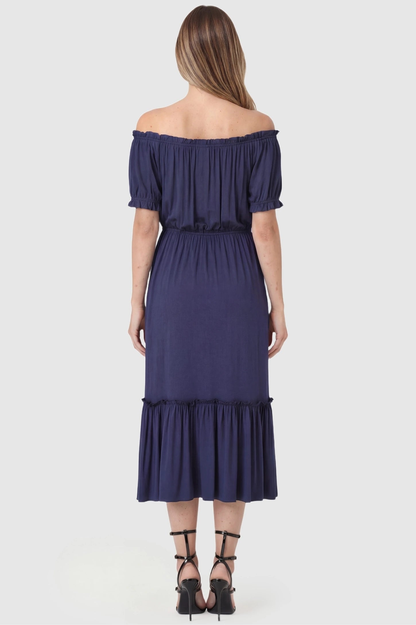 Ruffle Off-The-Shoulder Tiered Maternity Dress Ruffle Off-The-Shoulder Tiered Maternity Dress in Blue featuring a ruffled neckline detail on the back of a pregnant model.