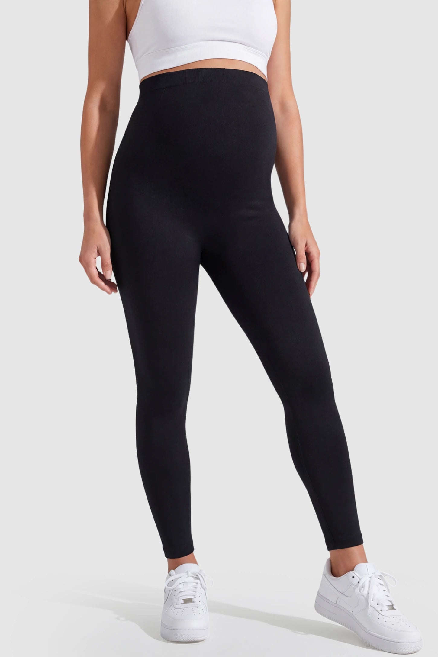 Over-The-Belly Full-Length Maternity Yoga Leggings Over-The-Belly Full-Length Maternity Yoga Leggings in black featuring contouring bodycon fit and supportive full panel on pregnant model.