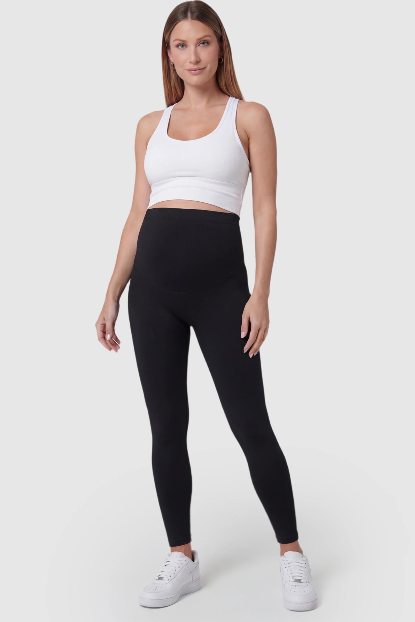 Over-The-Belly Full-Length Maternity Yoga Leggings Over-The-Belly Full-Length Maternity Yoga Leggings in black featuring contouring bodycon fit and supportive full panel on pregnant model.