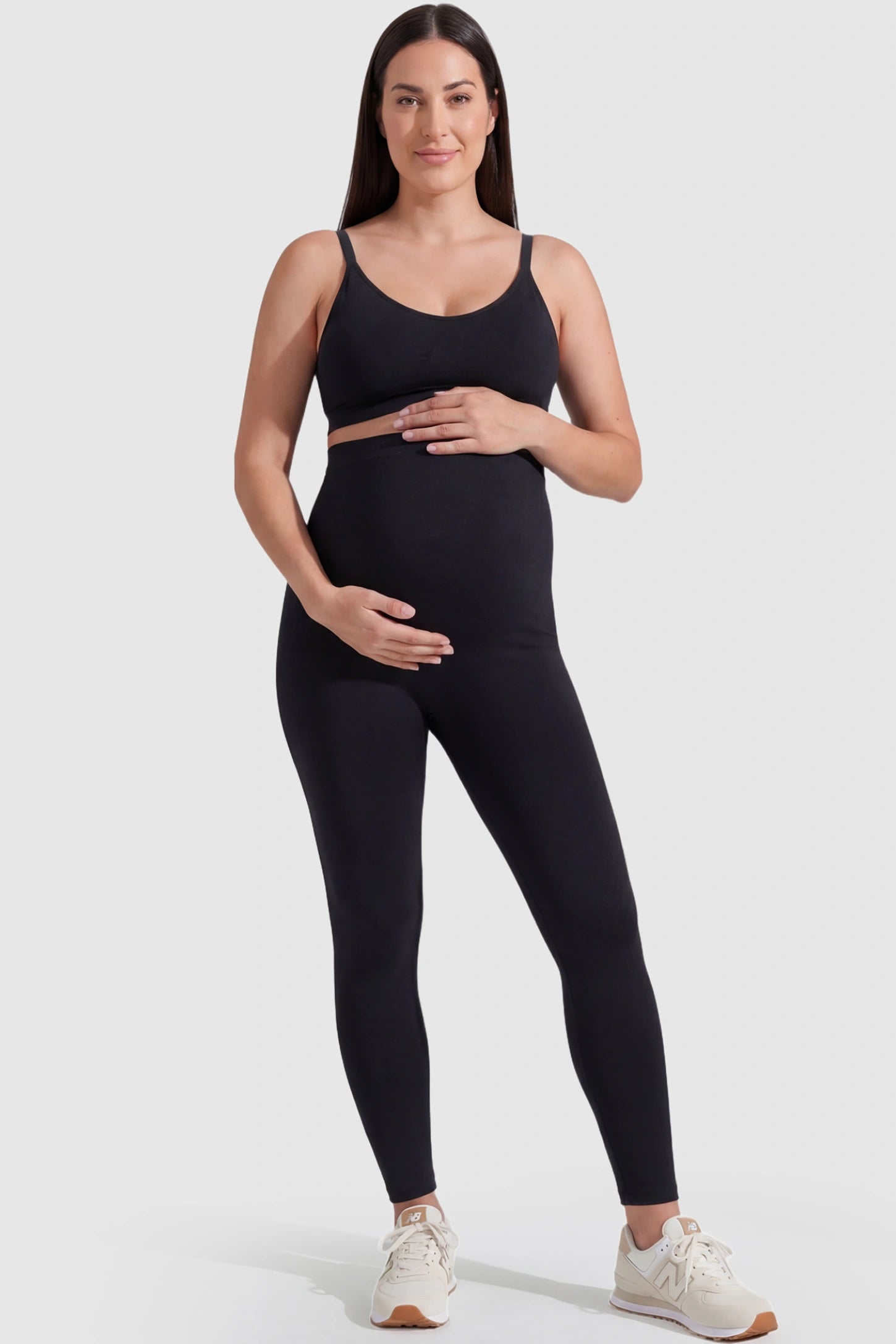 Over-The-Belly Full-Length Maternity Yoga Leggings Over-The-Belly Full-Length Maternity Yoga Leggings in black featuring contouring bodycon fit and supportive full panel on plus size pregnant model.