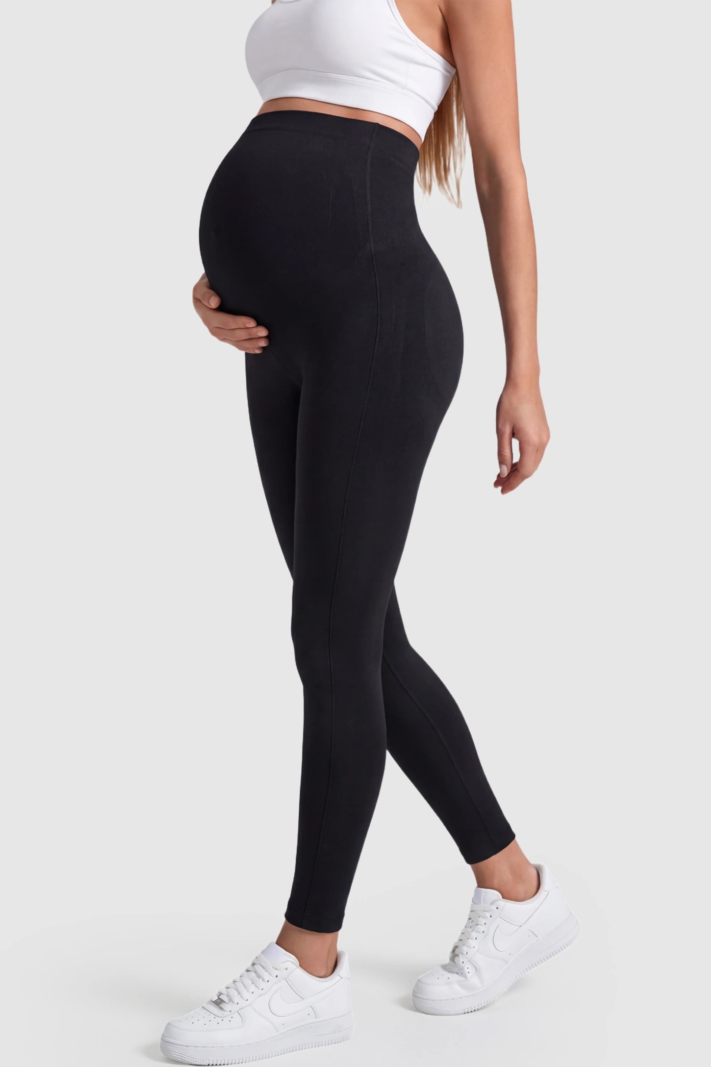 Over-The-Belly Full-Length Maternity Yoga Leggings Over-The-Belly Full-Length Maternity Yoga Leggings in black featuring contouring bodycon fit and supportive full panel on pregnant model.