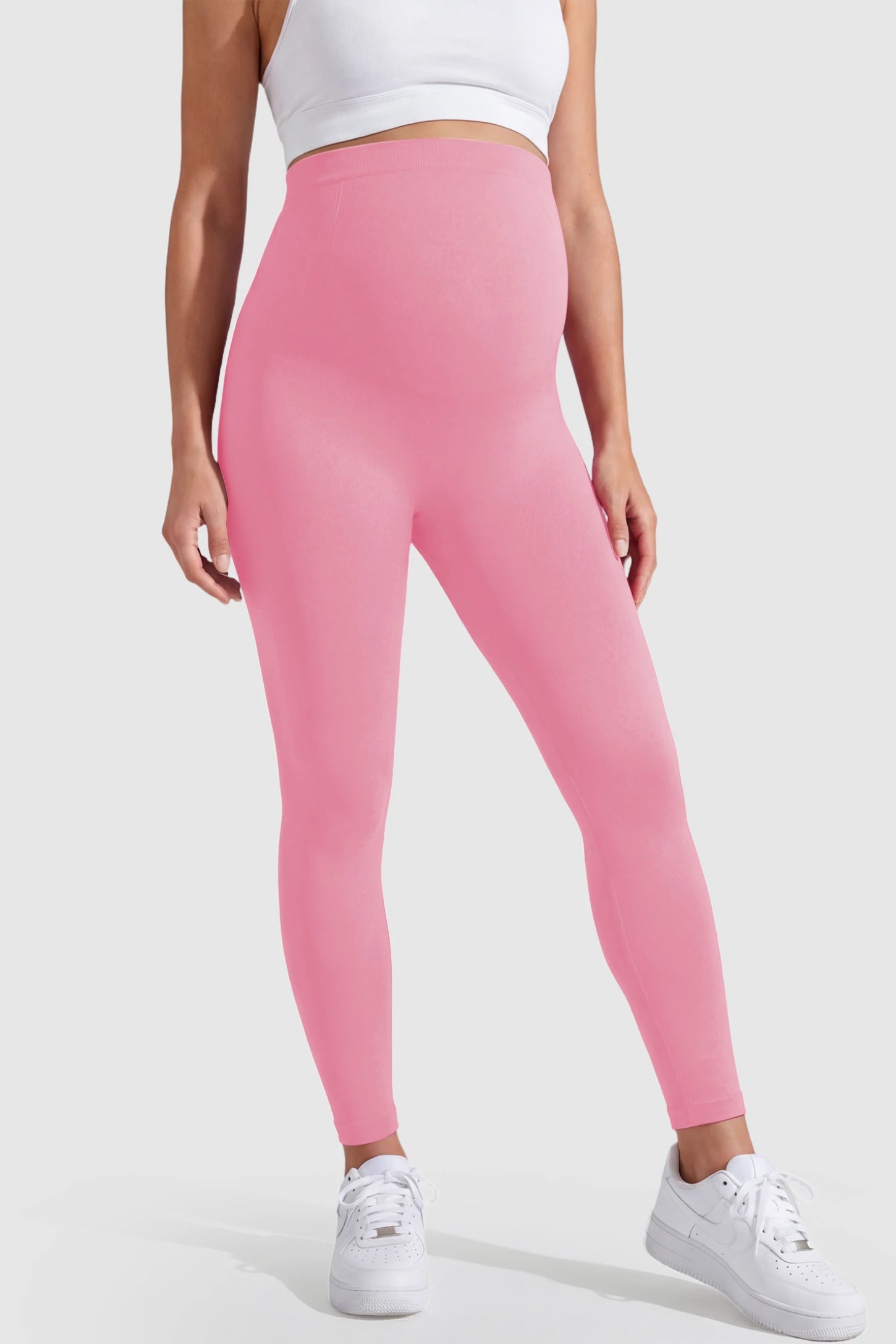 Over-The-Belly Full-Length Maternity Yoga Leggings Over-The-Belly Full-Length Maternity Yoga Leggings in coral pink featuring contouring bodycon fit and supportive full panel on pregnant model.