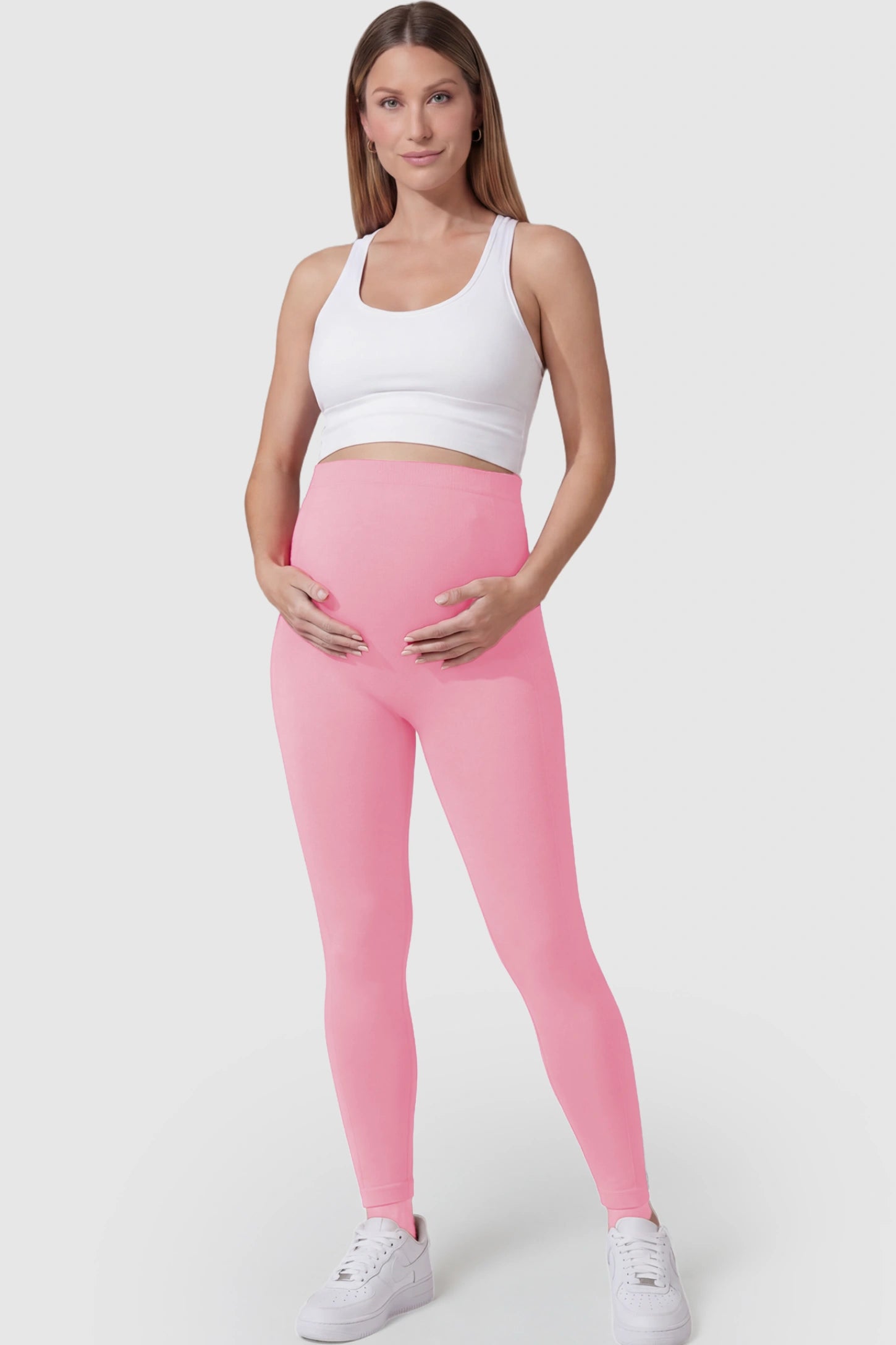 Over-The-Belly Full-Length Maternity Yoga Leggings Over-The-Belly Full-Length Maternity Yoga Leggings in coral pink featuring contouring bodycon fit and supportive full panel on pregnant model.