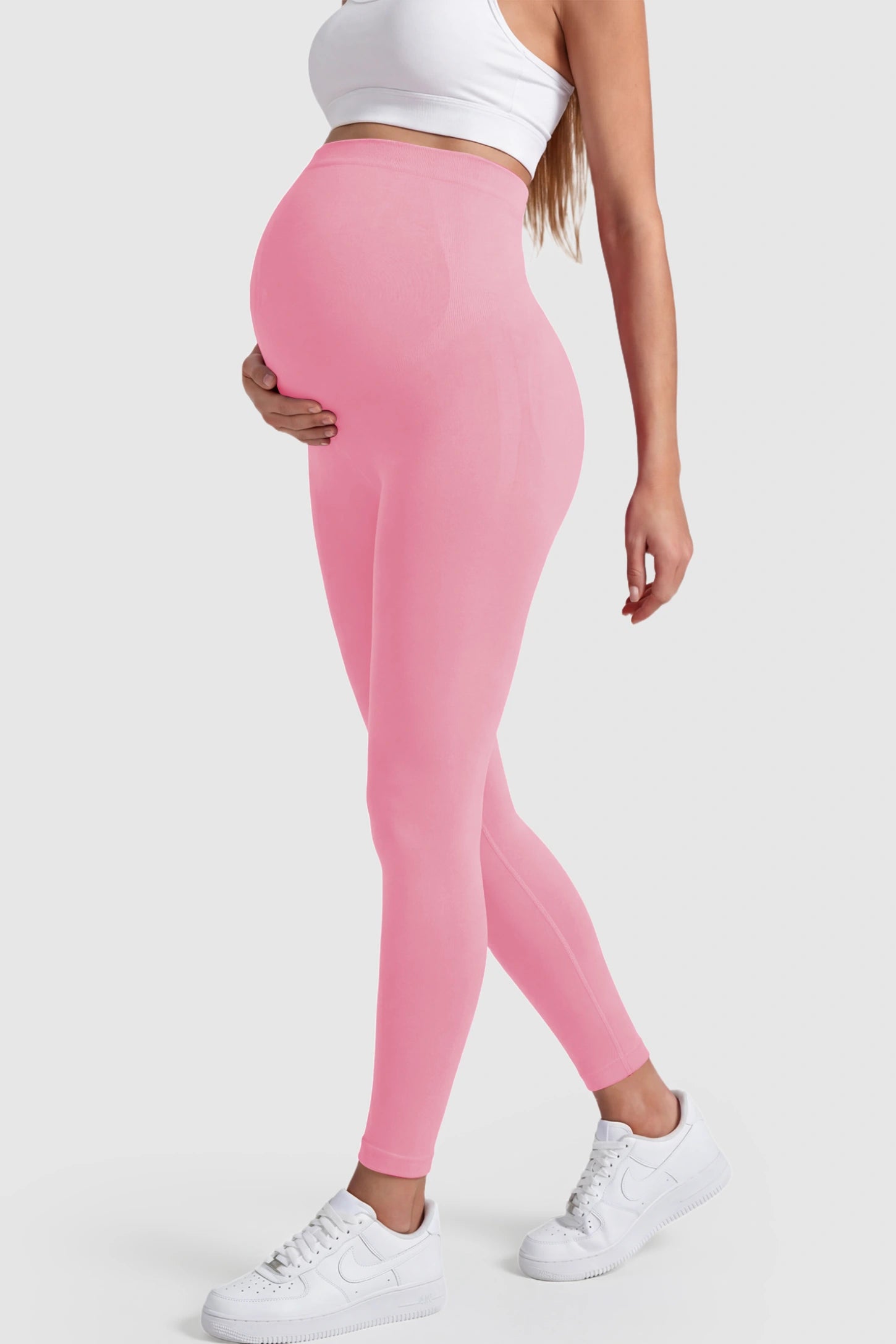 Over-The-Belly Full-Length Maternity Yoga Leggings Over-The-Belly Full-Length Maternity Yoga Leggings in coral pink featuring contouring bodycon fit and supportive full panel on pregnant model.