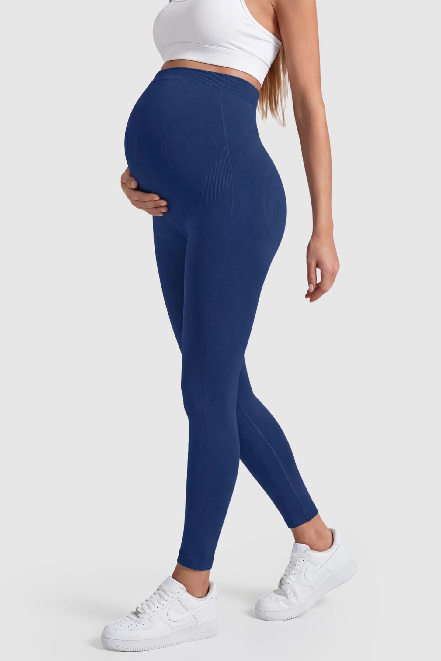 Over-The-Belly Full-Length Maternity Yoga Leggings Over-The-Belly Full-Length Maternity Yoga Leggings in navy blue featuring contouring bodycon fit and supportive full panel on pregnant model.